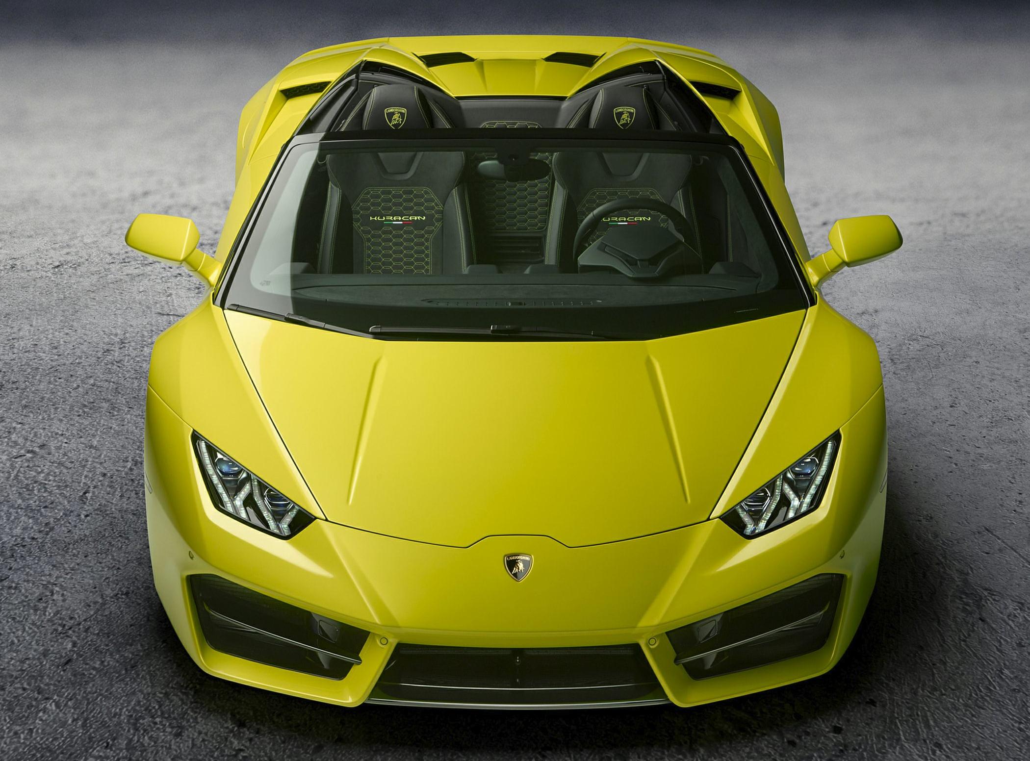 Front view of a yellow luxury convertible with sharp headlights