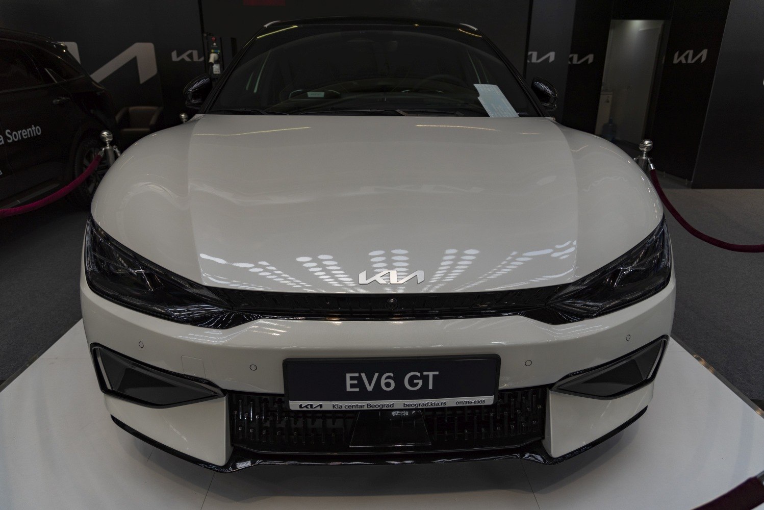 Sleek electric vehicle front with LED headlights and aerodynamic design.