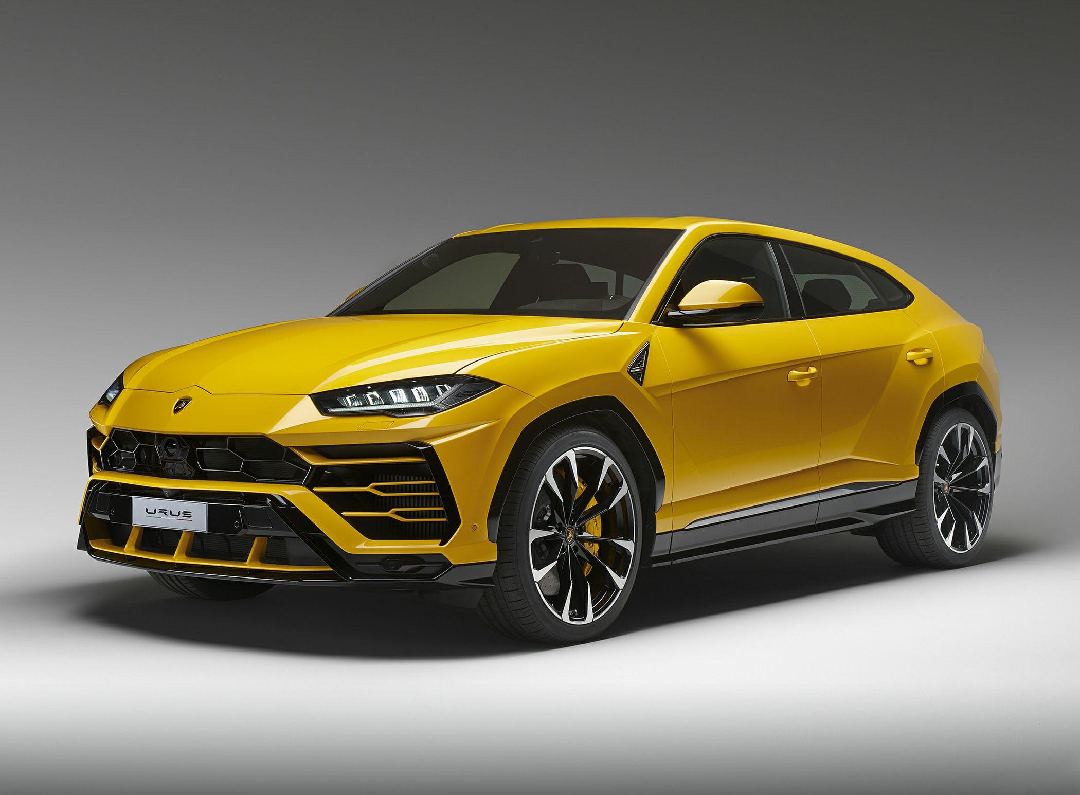 Front side view of a yellow sporty SUV with sharp lines and alloy wheels.
