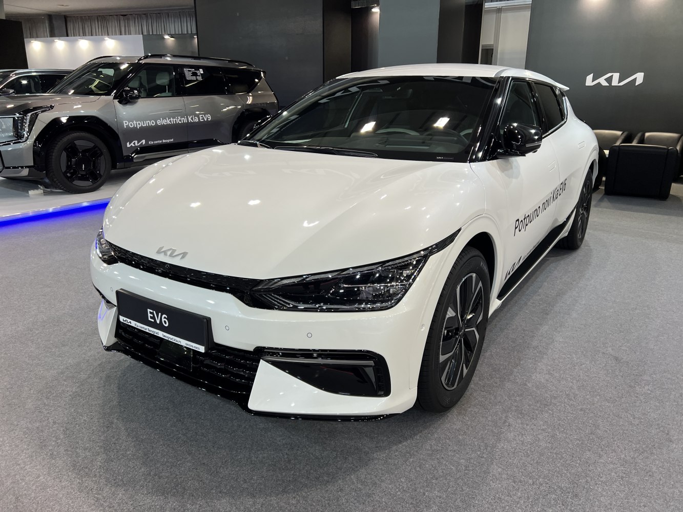 Front angled view of white electric crossover with sleek LED headlights