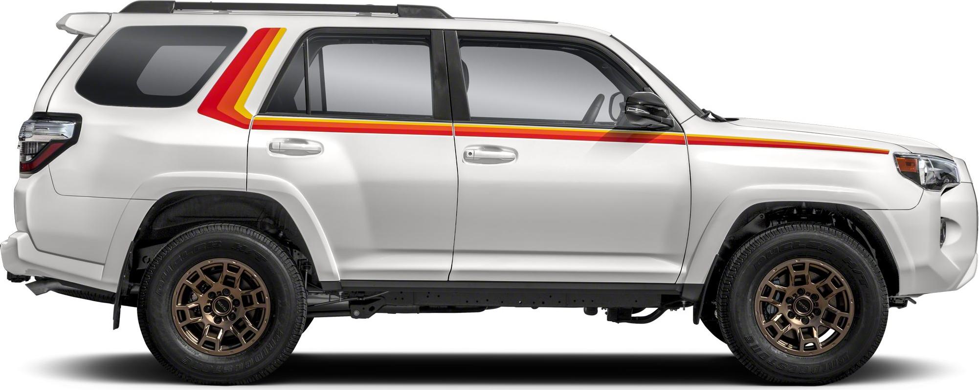 Side view of white SUV with retro multi-color stripes and bronze alloy wheels.