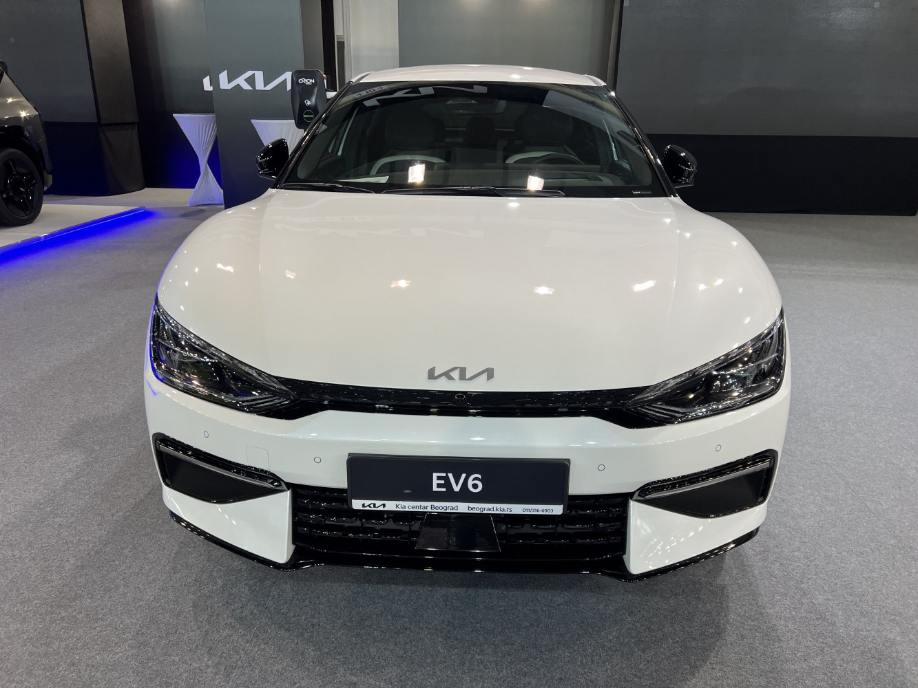 Close-up front view with headlights and grille of a white electric vehicle