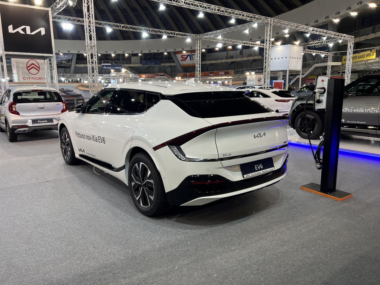 Rear view of electric SUV with charging station