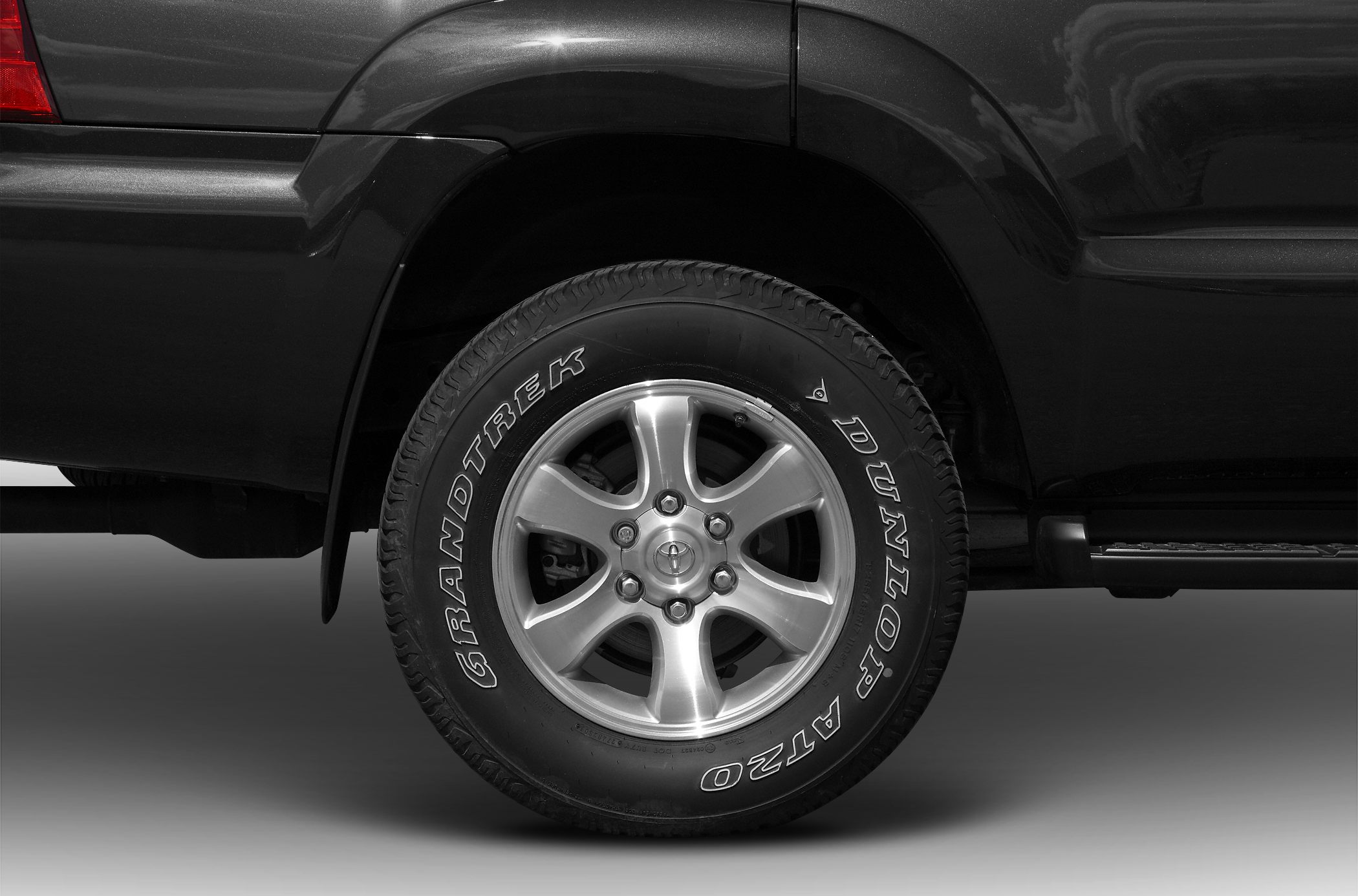 Alloy wheel with Dunlop Grandtrek AT20 tire on SUV rear side