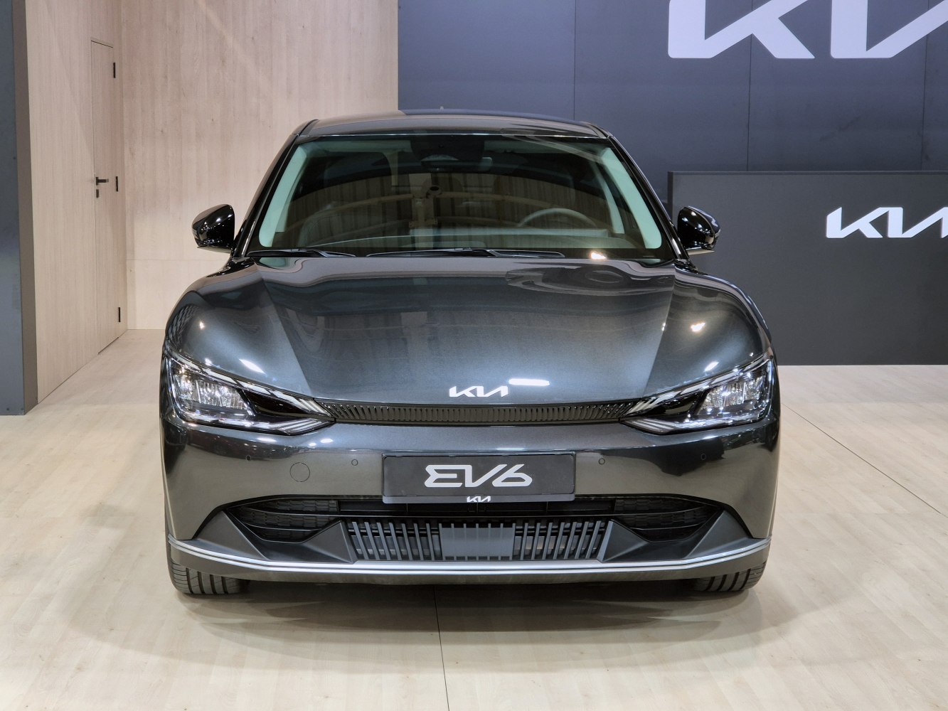 Front view of sleek EV vehicle with distinctive headlights and grille