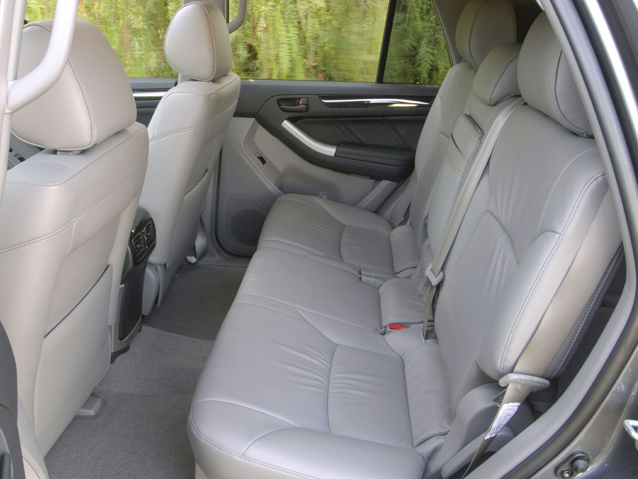 Spacious rear leather seat with door panel and rear air vents.
