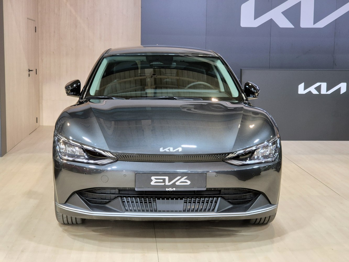 Front view of an electric crossover with sleek LED headlights and modern grille design.