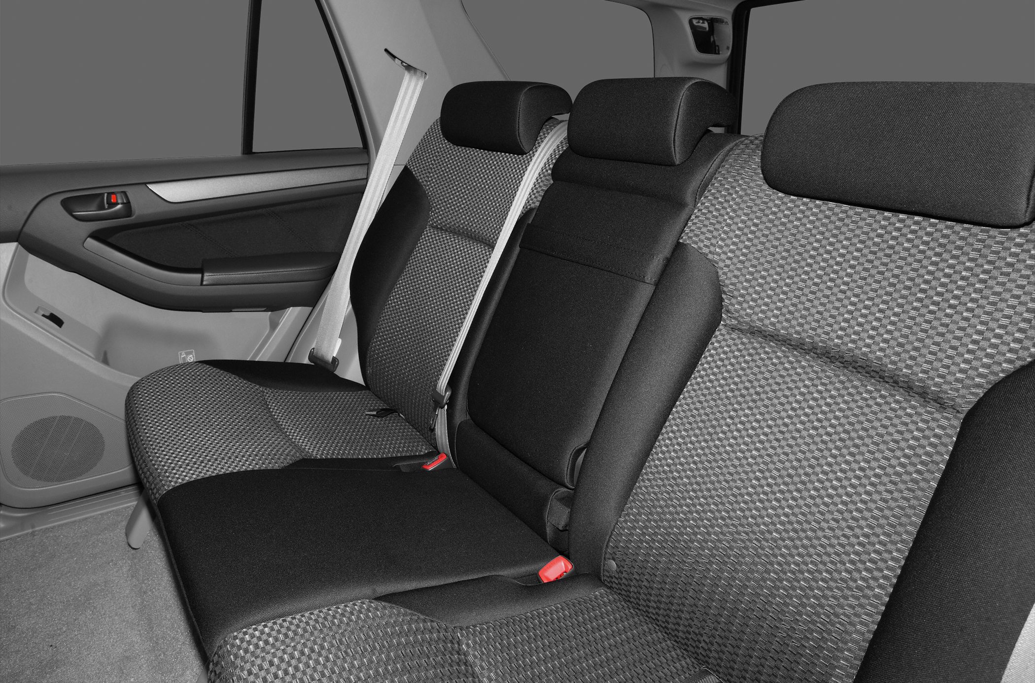 Rear seat fabric upholstery and integrated seat belts