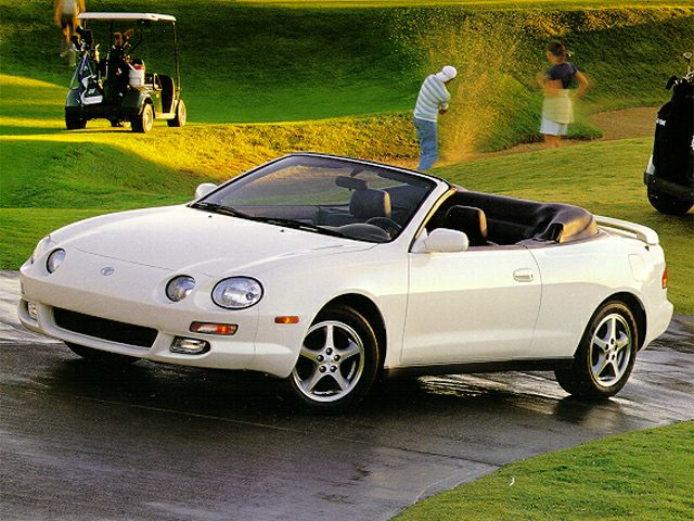 White convertible sports car with round headlights and alloy wheels
