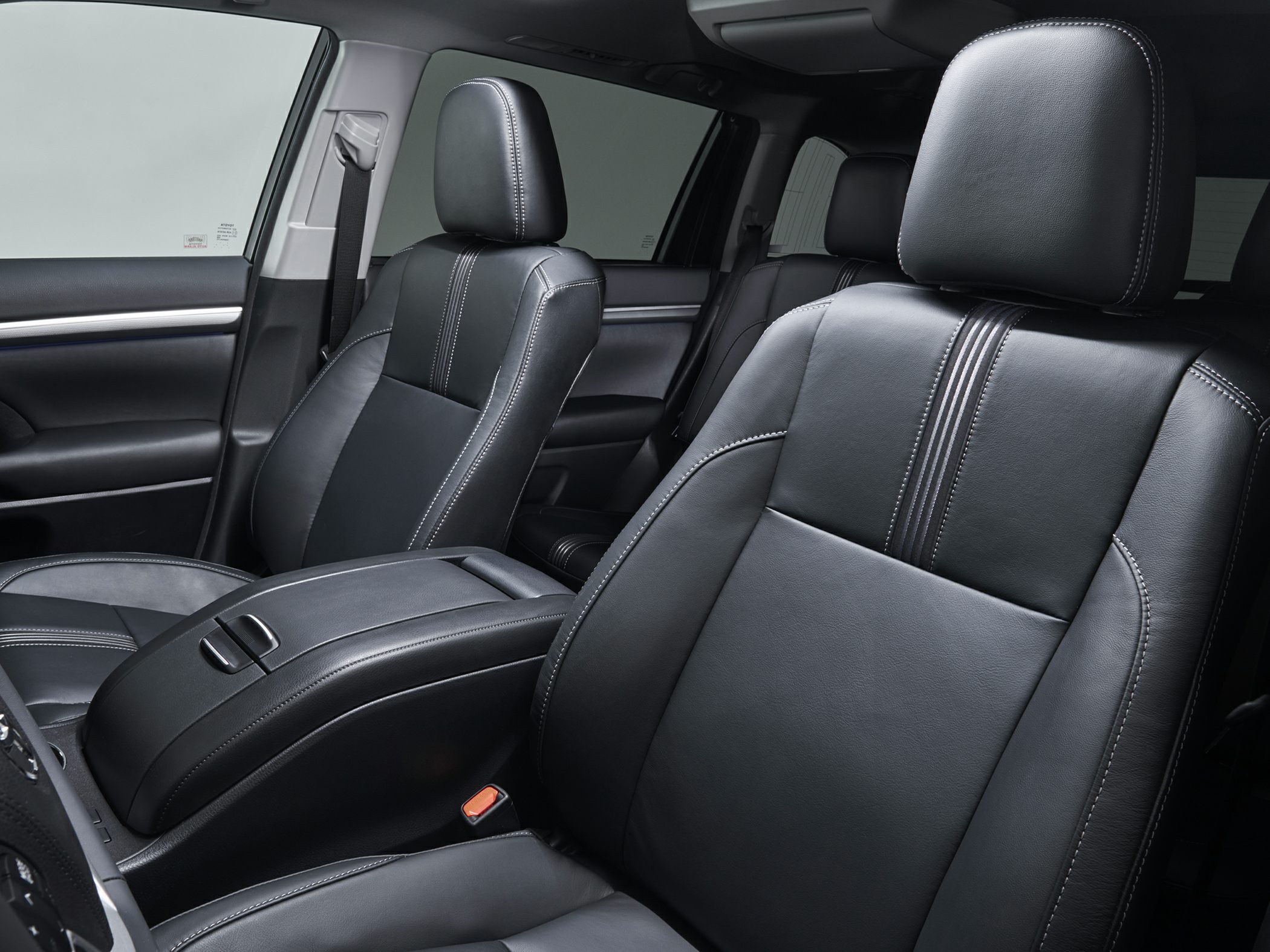 Close-up of black leather front seats with detailed stitching and center console