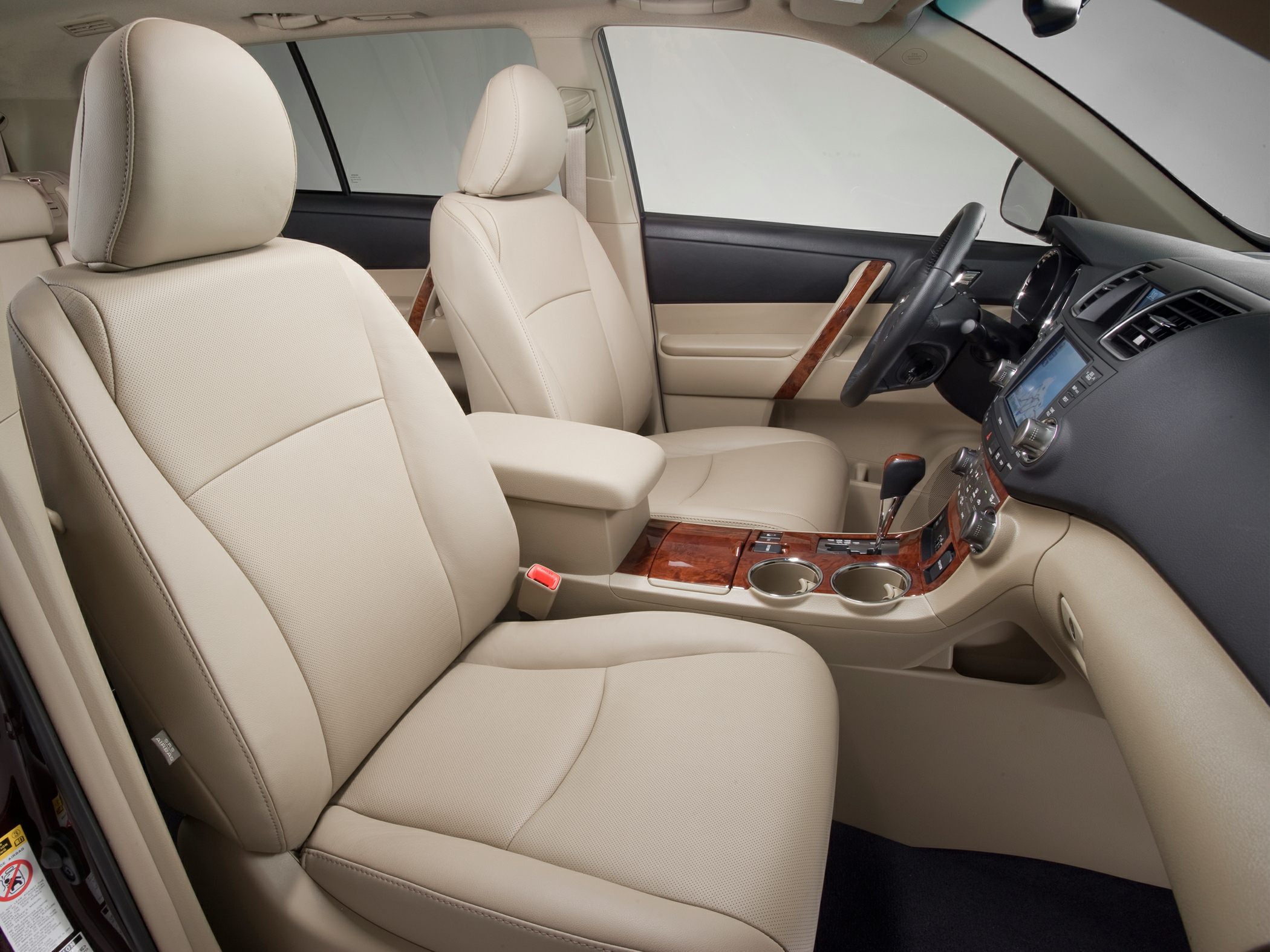 Beige leather seats with wood trim and center console in car interior