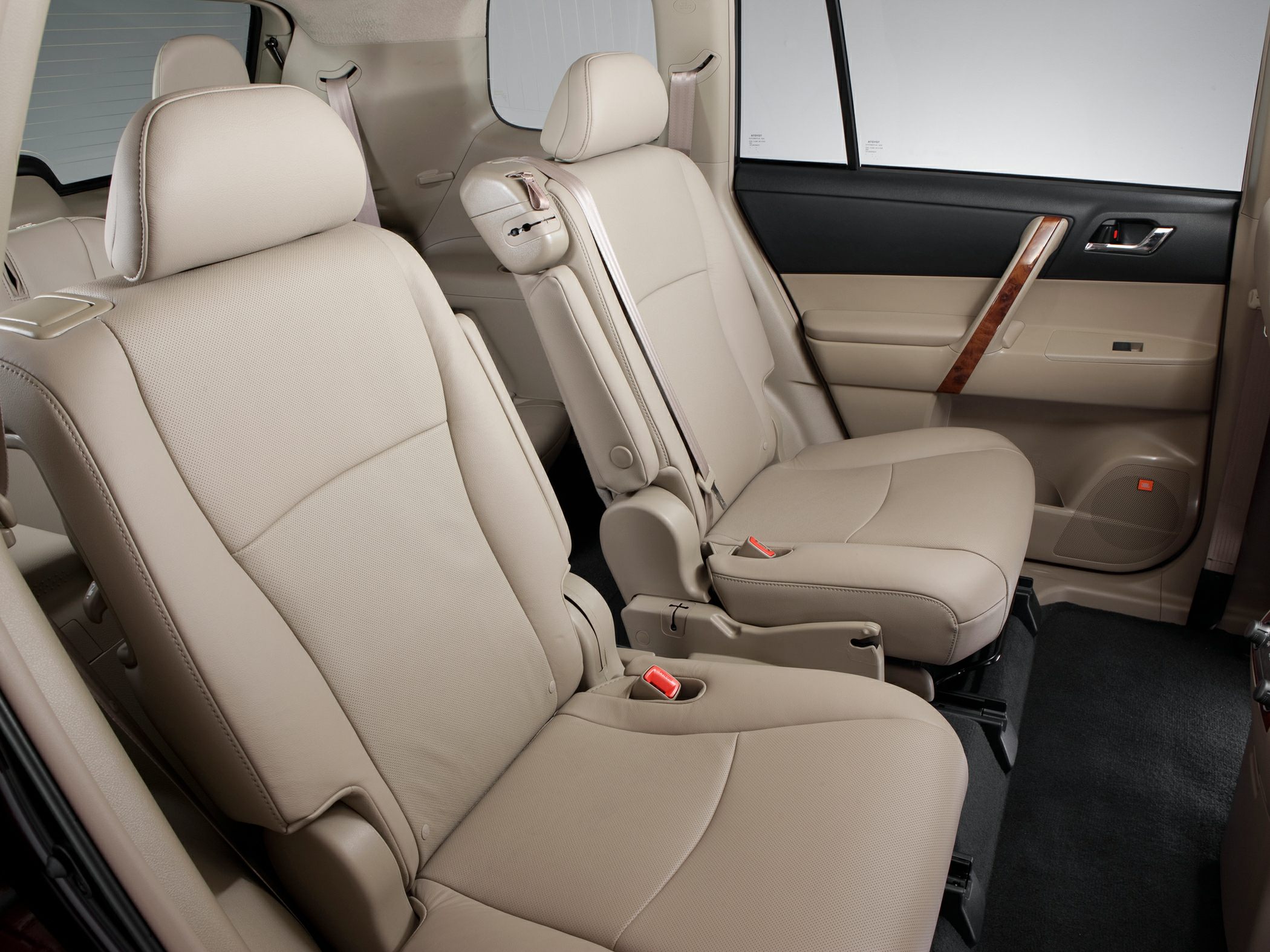 Beige leather rear seats with armrests and spacious legroom in SUV interior