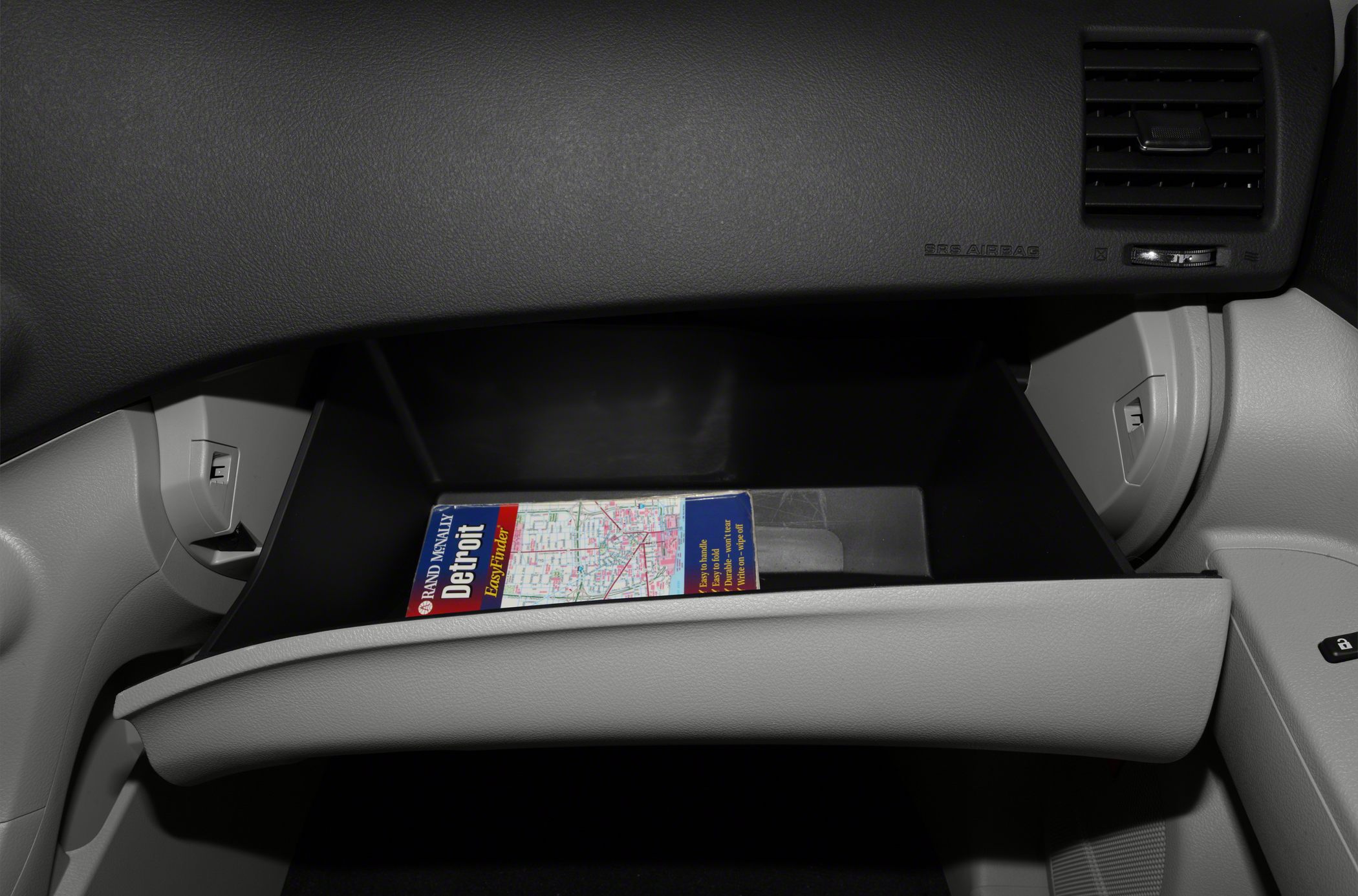Open glovebox with a Detroit city map inside