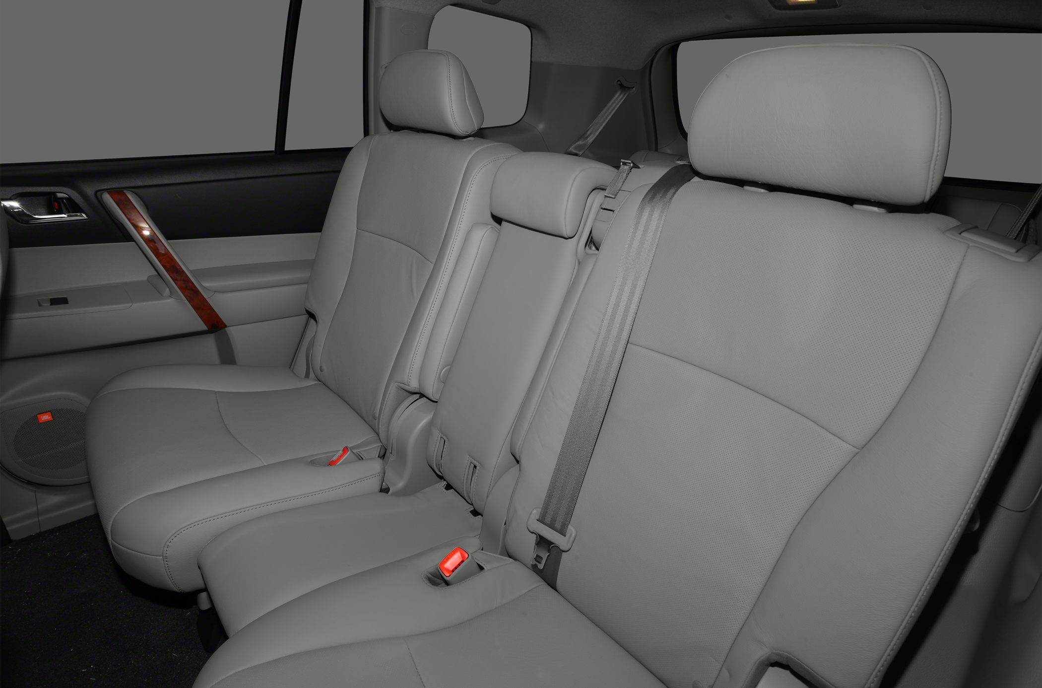 Rear leather seats with headrests and seat belts in an SUV interior