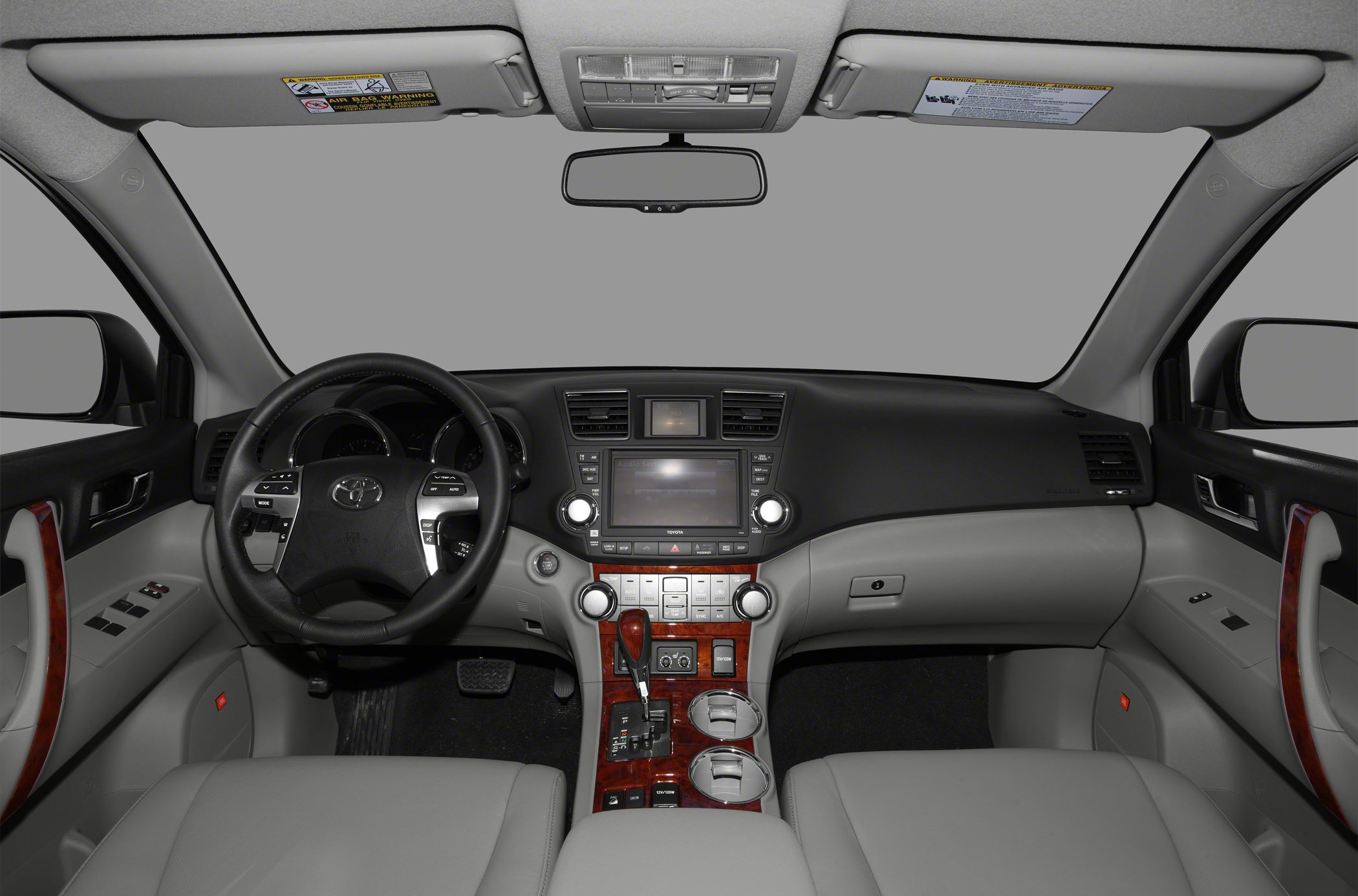 Dashboard, steering wheel, center console with wooden trim and controls