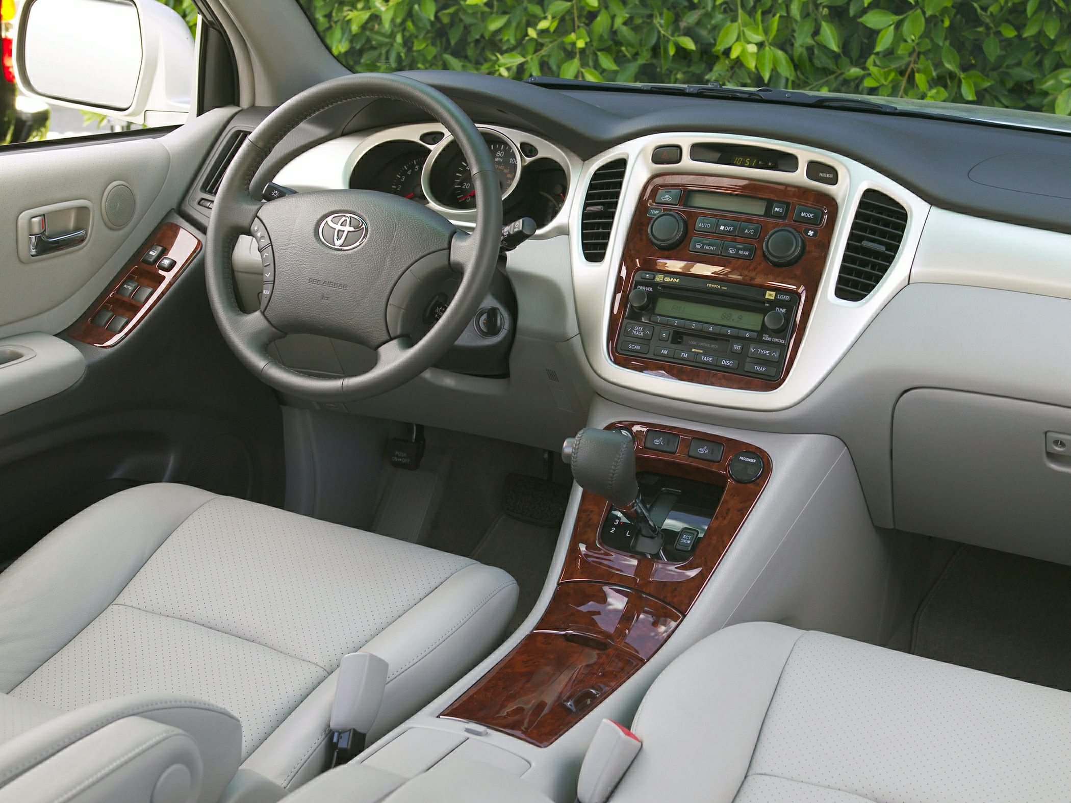 Interior dashboard with woodgrain trim, gear shift, and steering wheel
