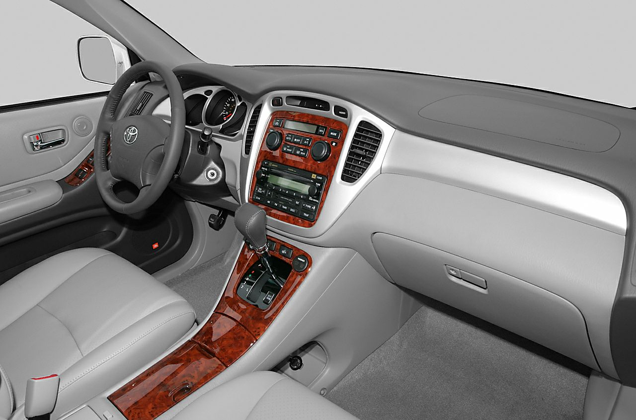 Interior dashboard and wood-trimmed center console with gear shift and steering wheel