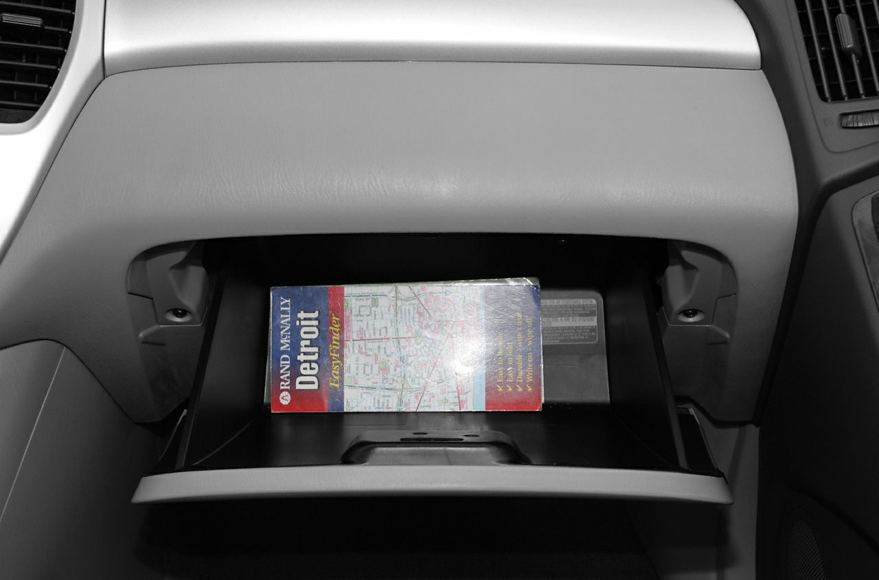 Glove compartment with map inside vehicle interior.