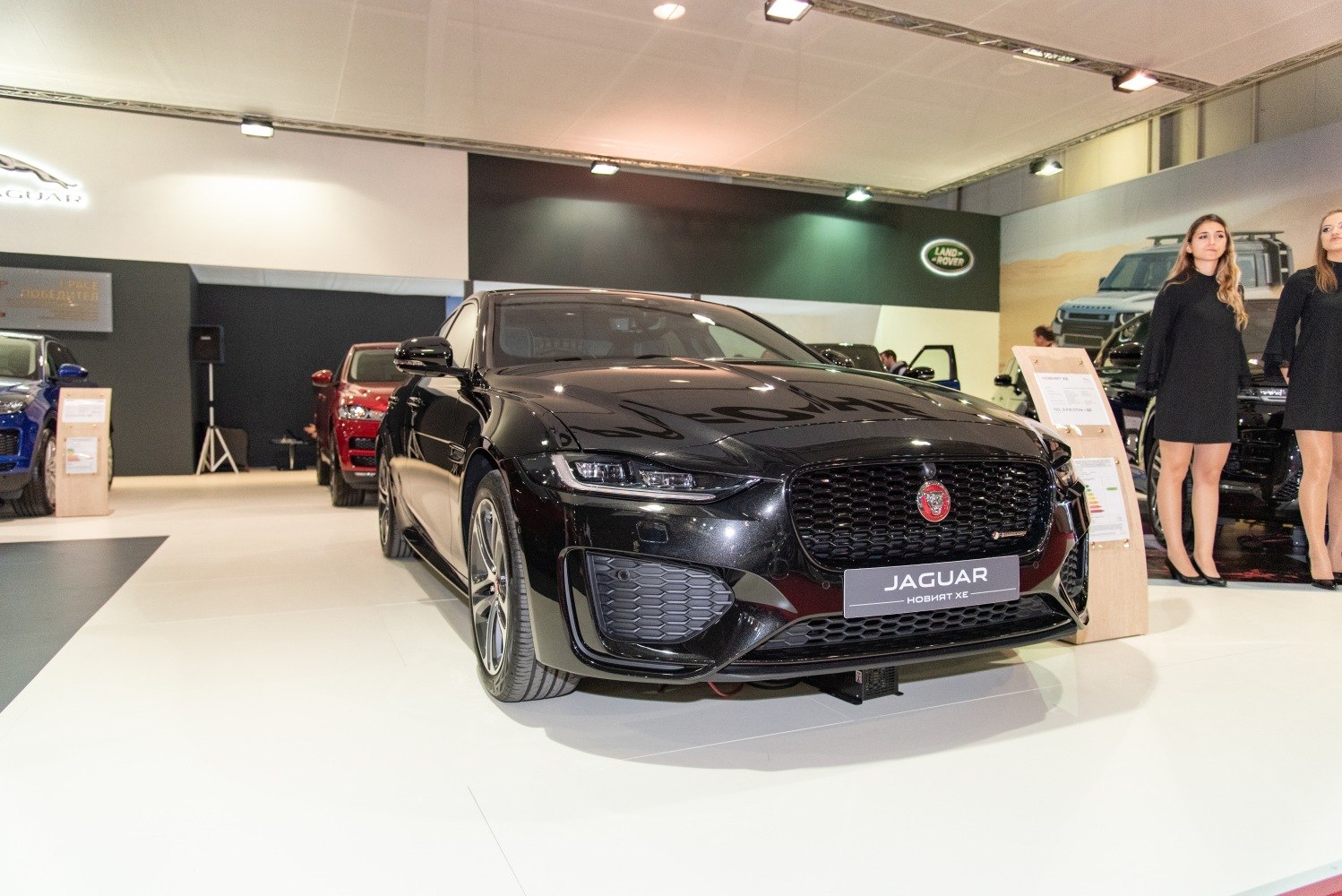 Front view of sleek black sedan with aggressive grille and modern headlights