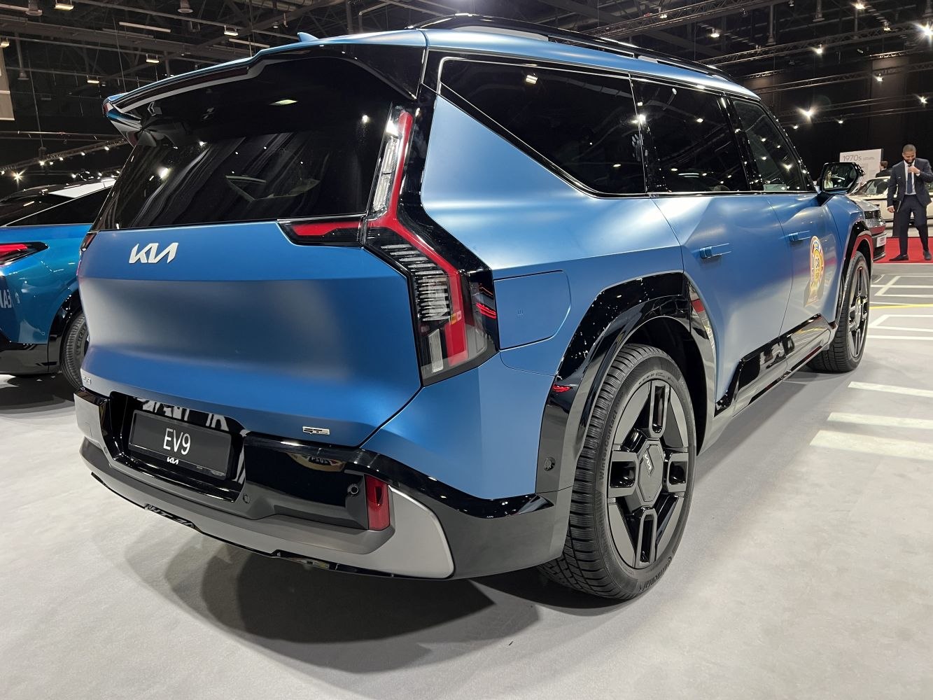 Rear view of a sleek electric SUV with distinctive taillights and black accents