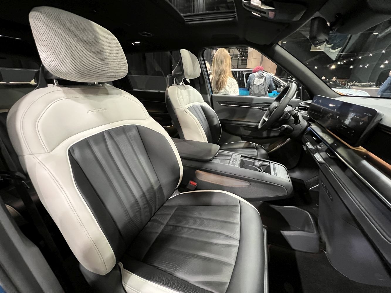 Two-tone seats with modern digital dashboard in spacious cabin.