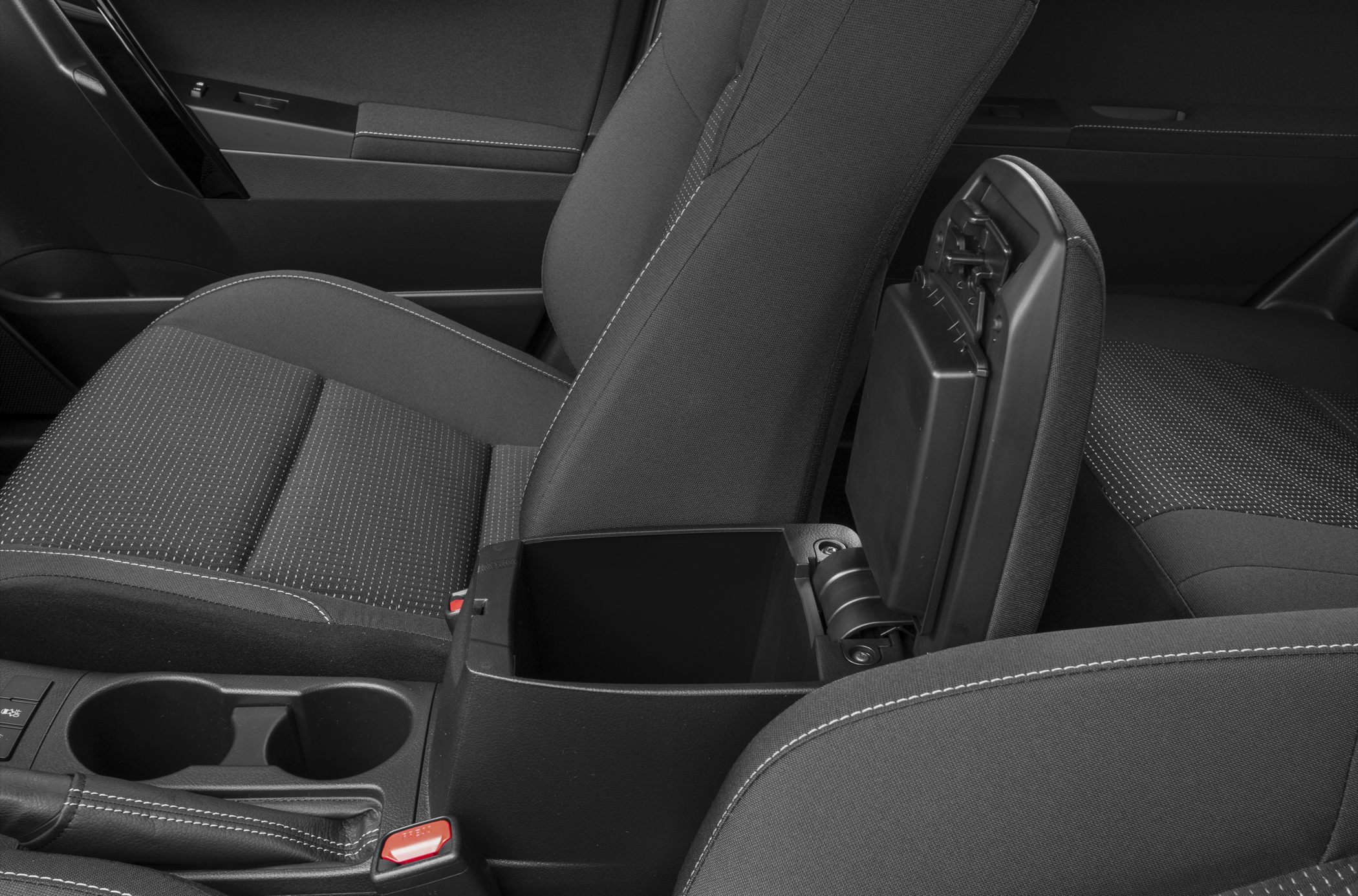 Center console storage compartment and dual cup holders with fabric car seats.