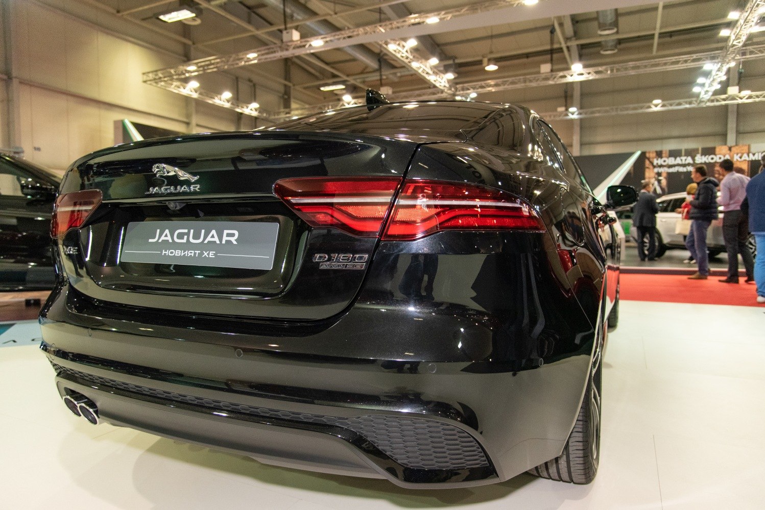 LED tail lights and dual exhaust pipes on a black luxury sedan rear.