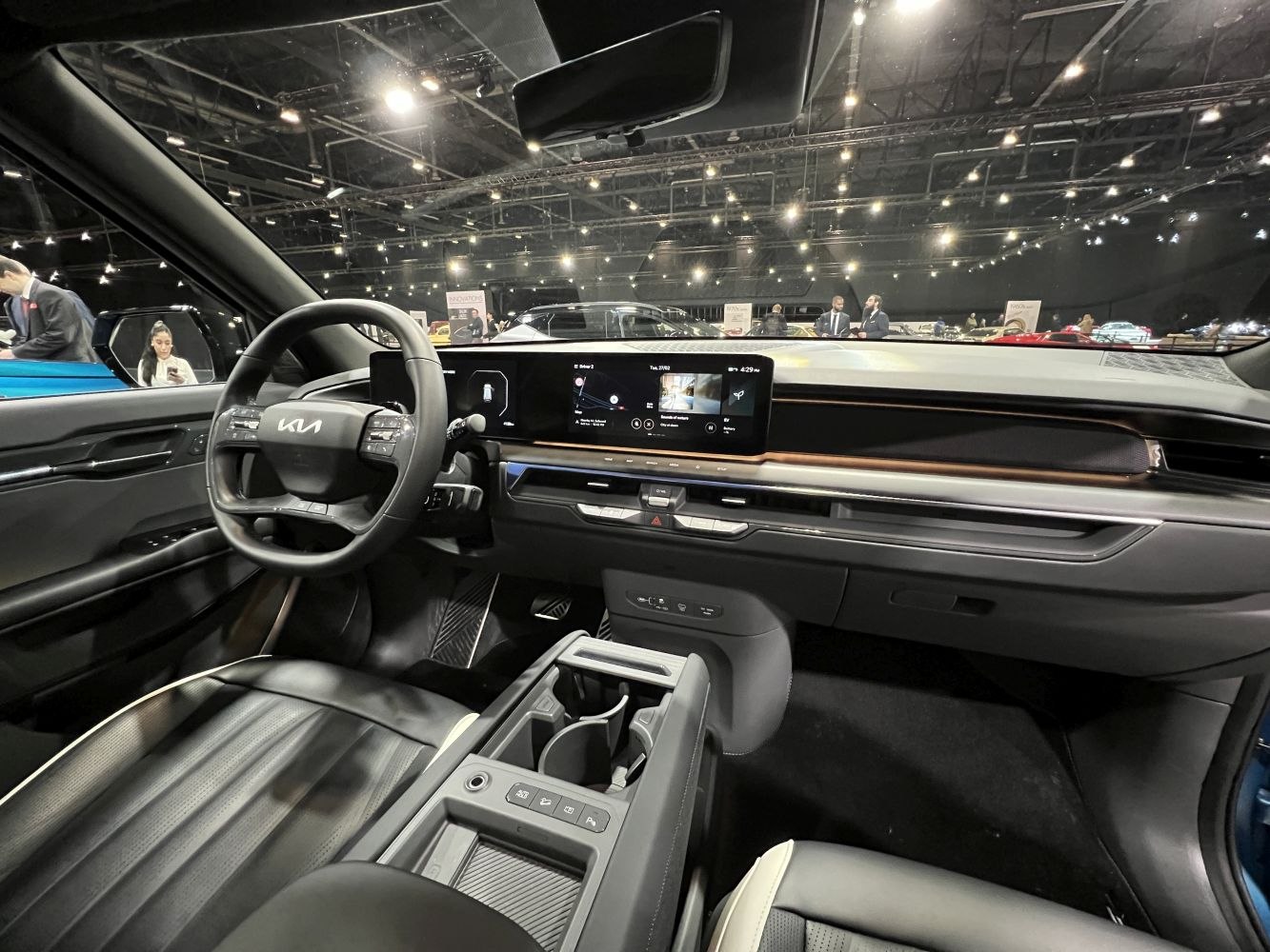 Electric vehicle interior with digital dashboard and multifunction steering wheel