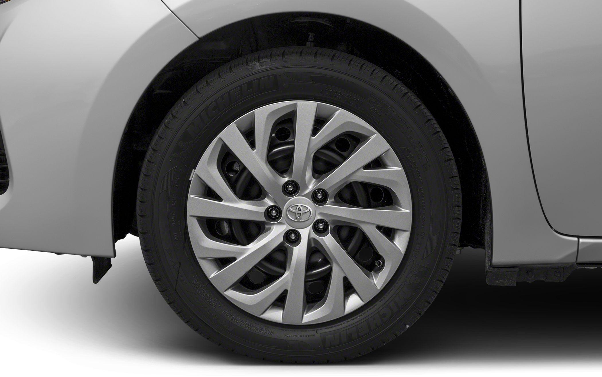 Multi-spoke alloy wheel with Michelin tire on a car.