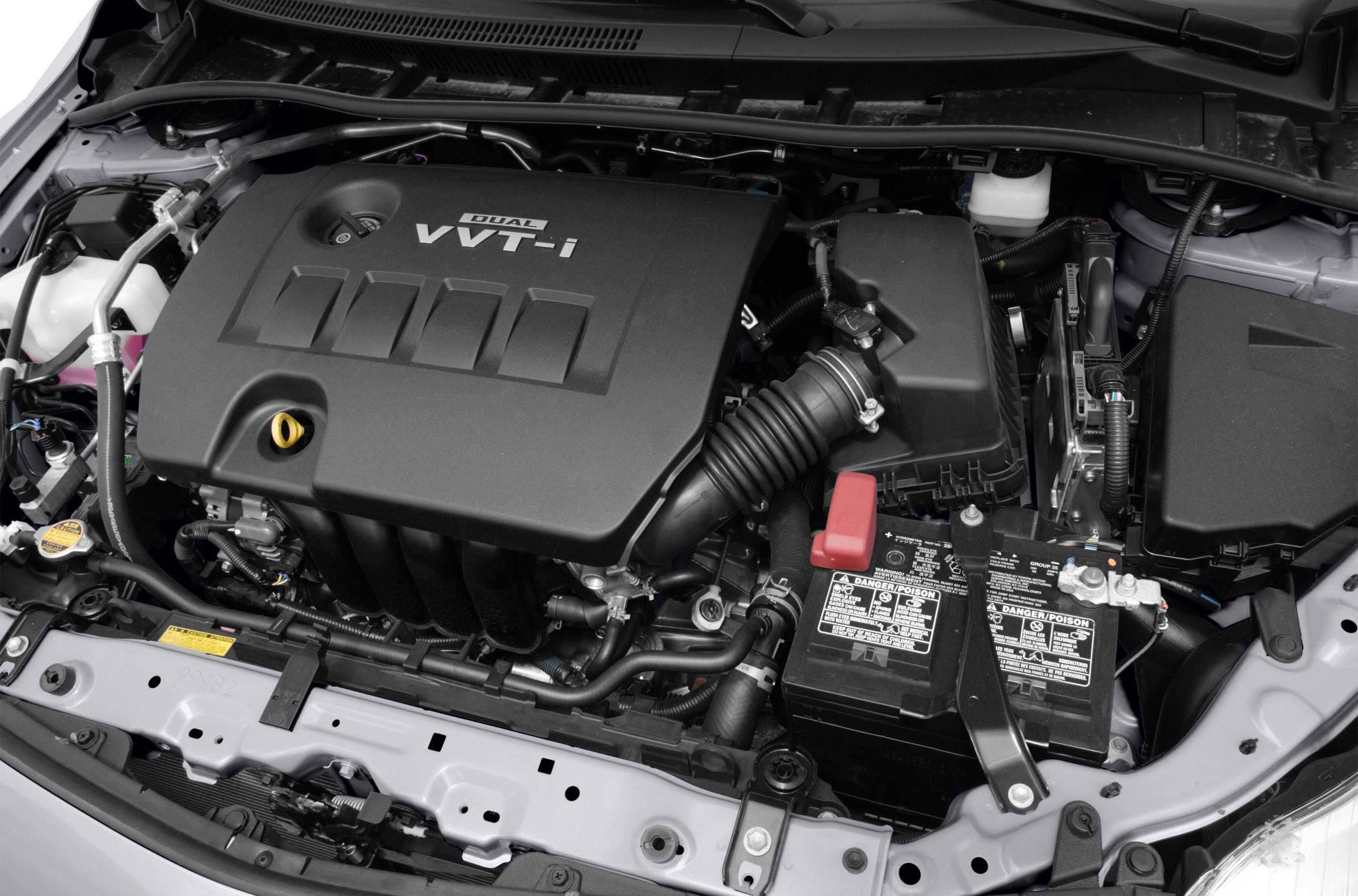 Dual VVT-i engine cover and battery layout in an engine bay