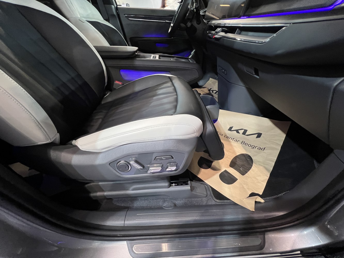 Close-up of front leather seat with electric adjustment controls