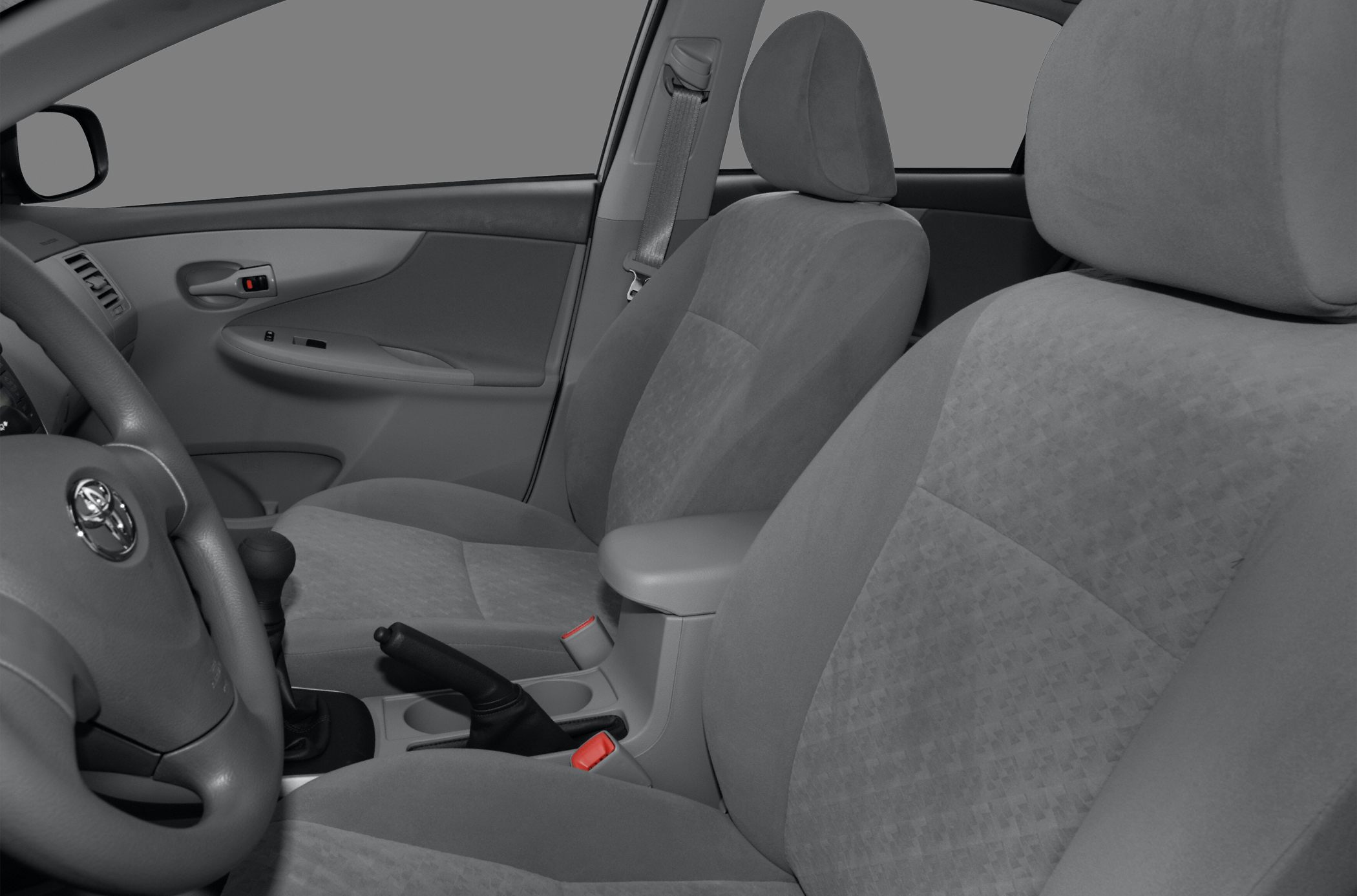 Front interior seats with fabric upholstery and central console with manual handbrake