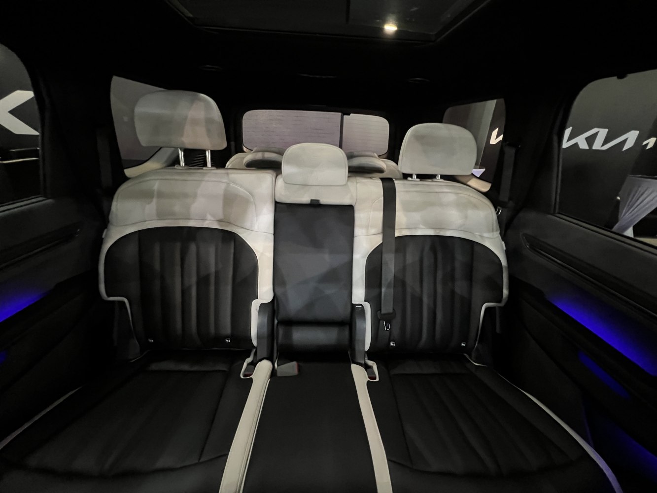 Two-tone black and white leather rear seats with headrests and modern details
