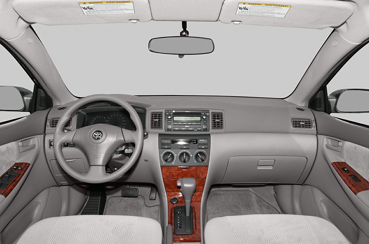 Dashboard and interior layout with wood trim and automatic gear shift