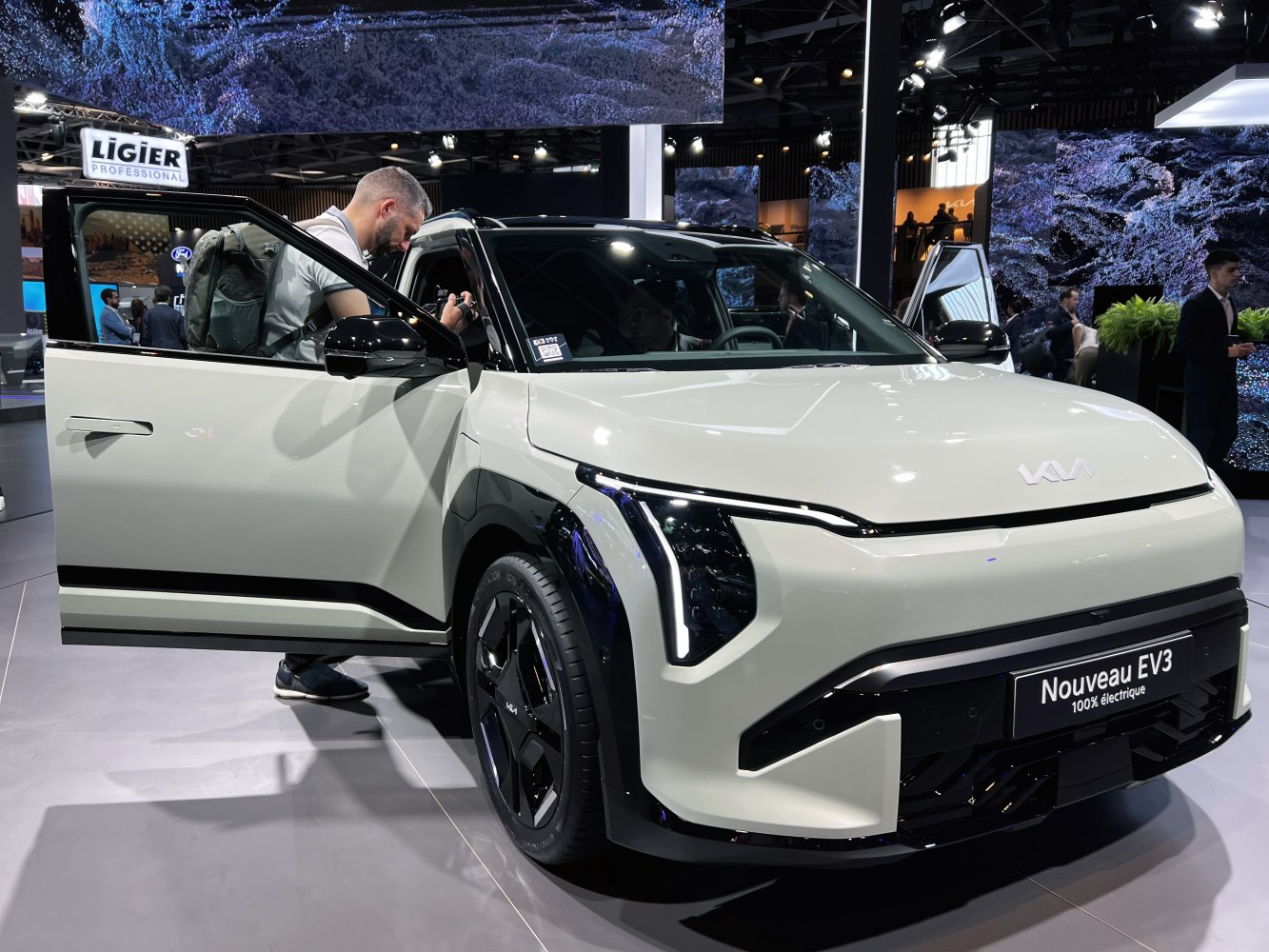 Front view of electric SUV with vertical LED headlights and black wheel arches