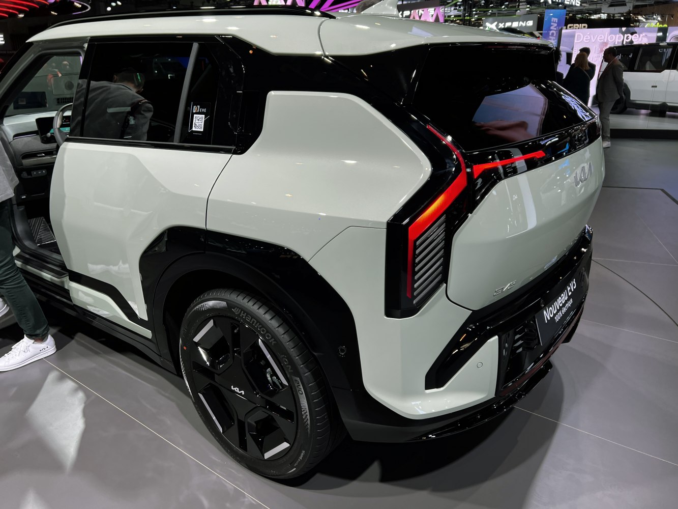 Angular LED taillights and modern black-accented wheel of EV3 rear side