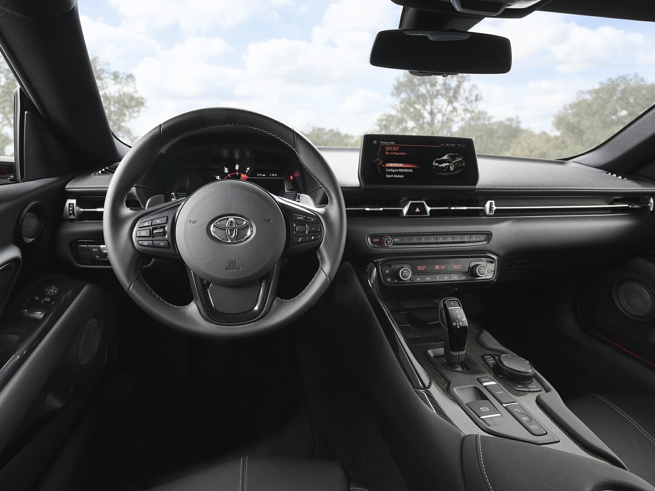 Interior view of steering wheel, dashboard, and center console with infotainment screen