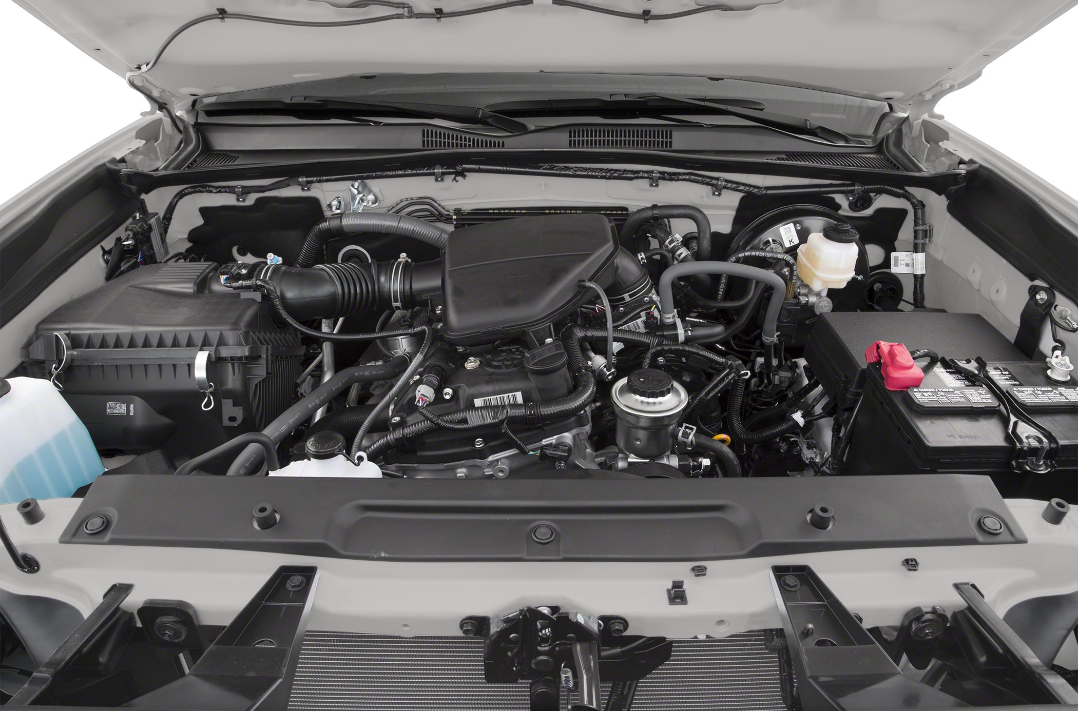 Close-up of engine bay with air intake, battery, and fluid reservoirs.