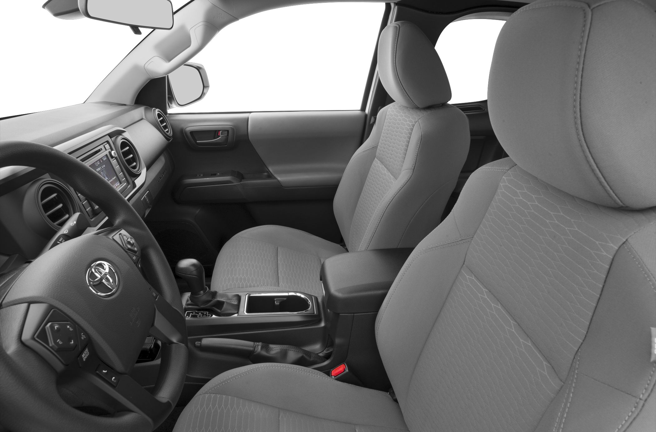 Front seats, dashboard, and center console with gear shifter and armrest