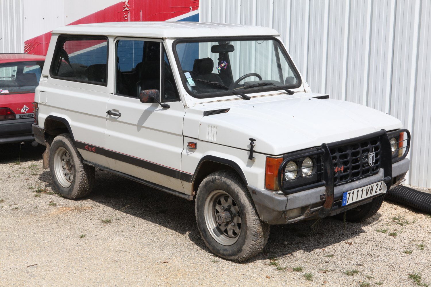 White 4x4 off-road vehicle with bull bar and rugged tires