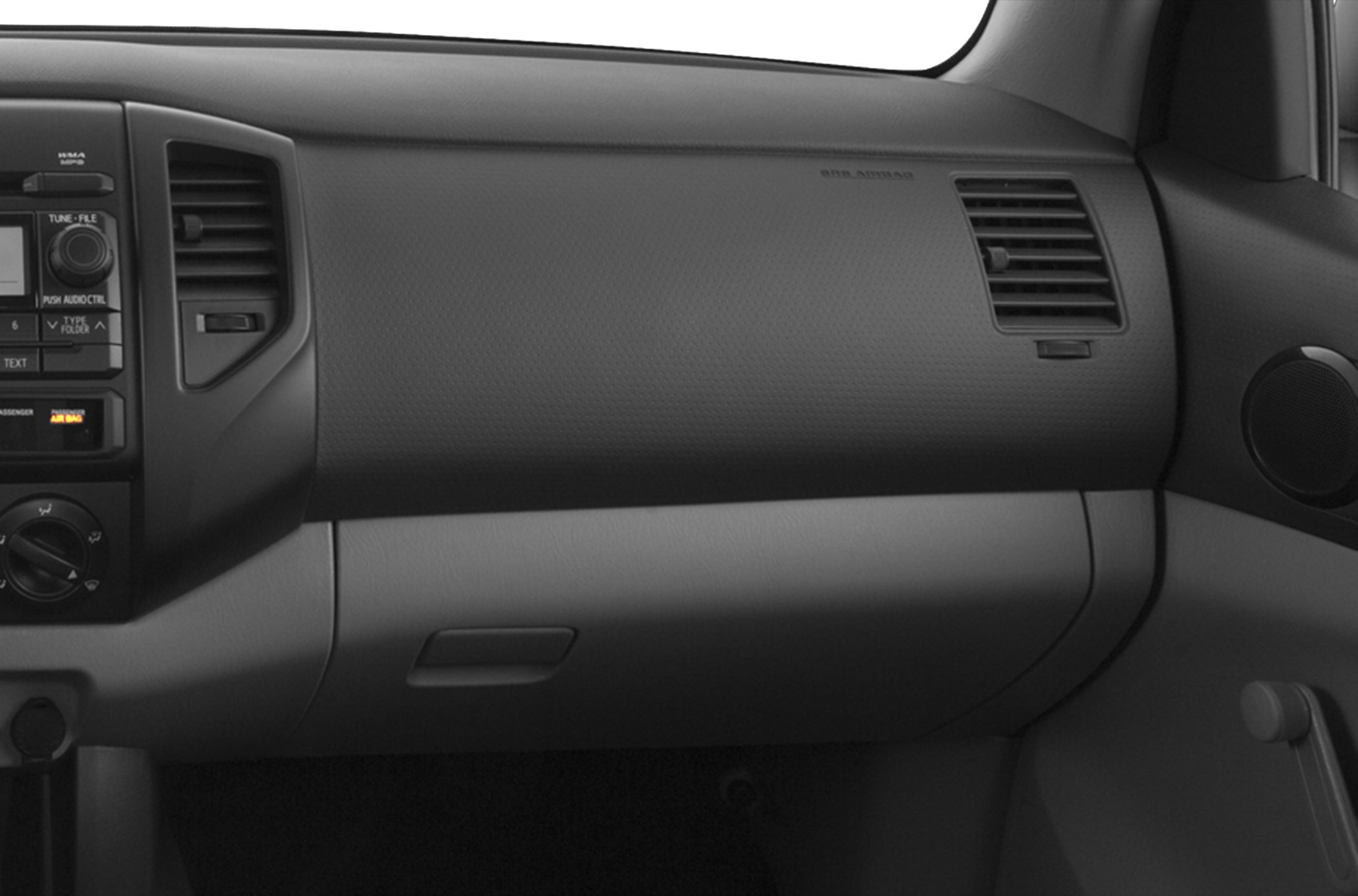 Dashboard with air vents, glove compartment, and control knobs
