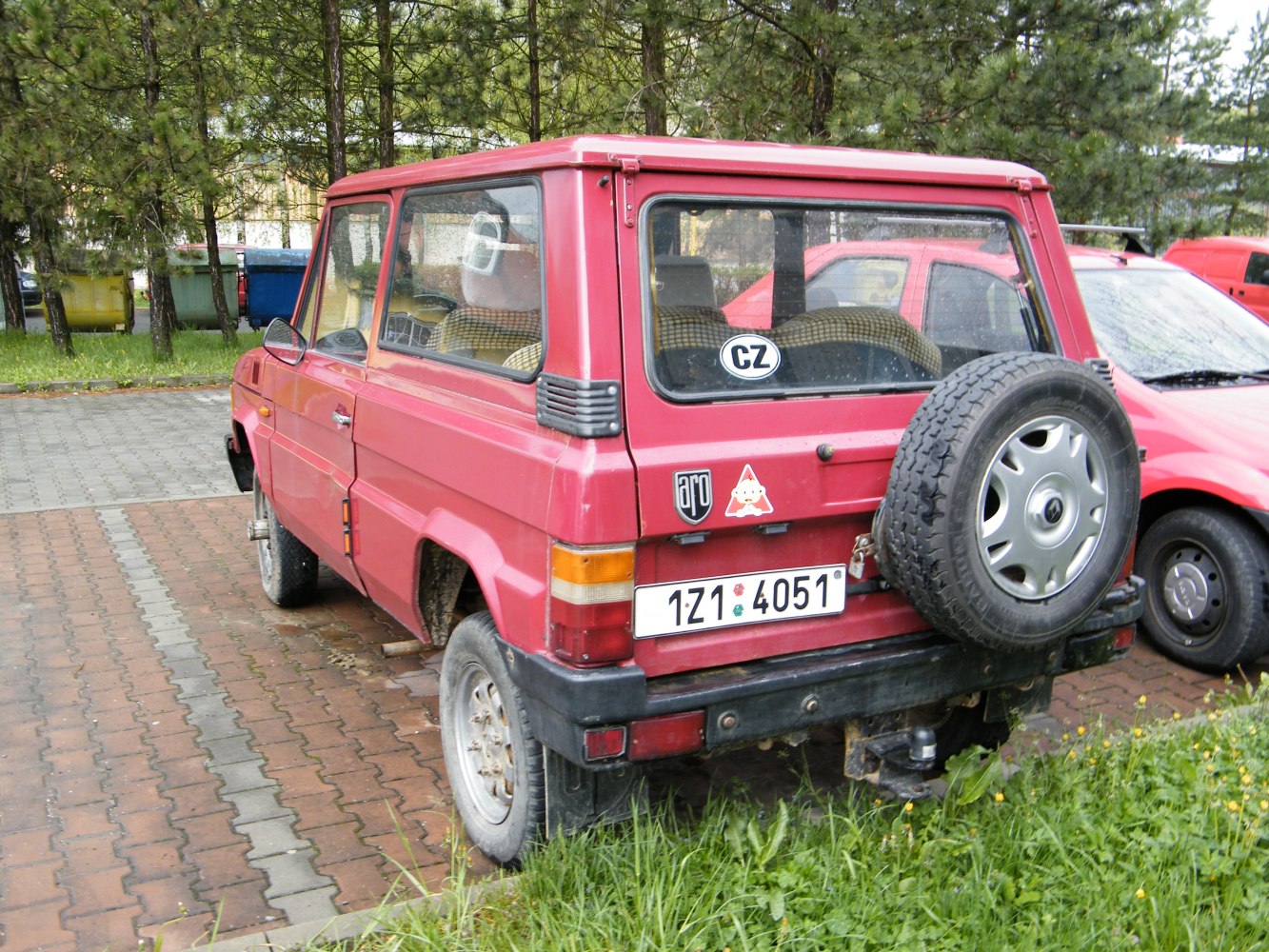 Boxy off-road SUV with rear-mounted spare tire and detailed rear features