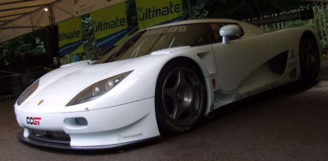 White racing coupe with aerodynamic front and performance tires.