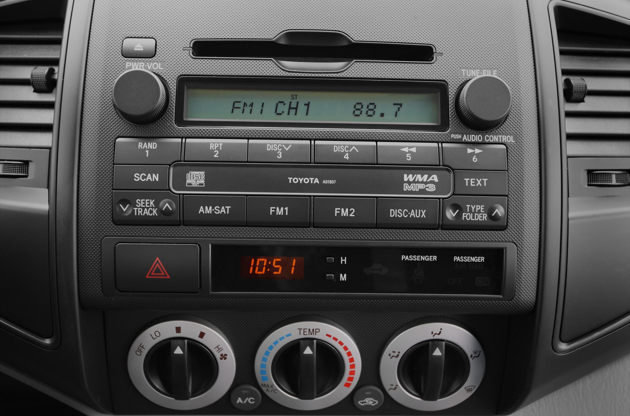 Car radio and manual climate control panel with buttons and dials