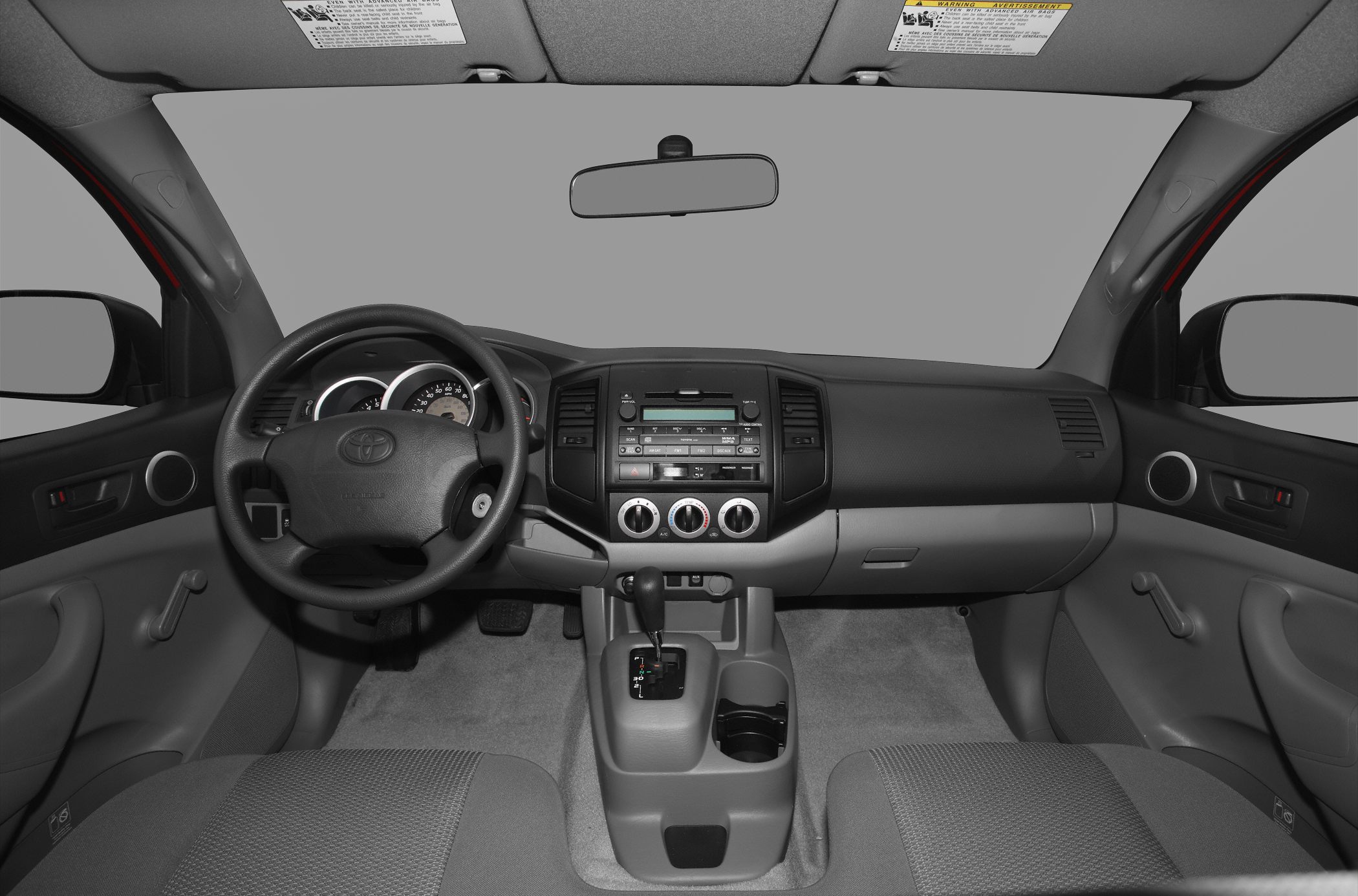 Interior dashboard and manual window controls of mid-2000s pickup