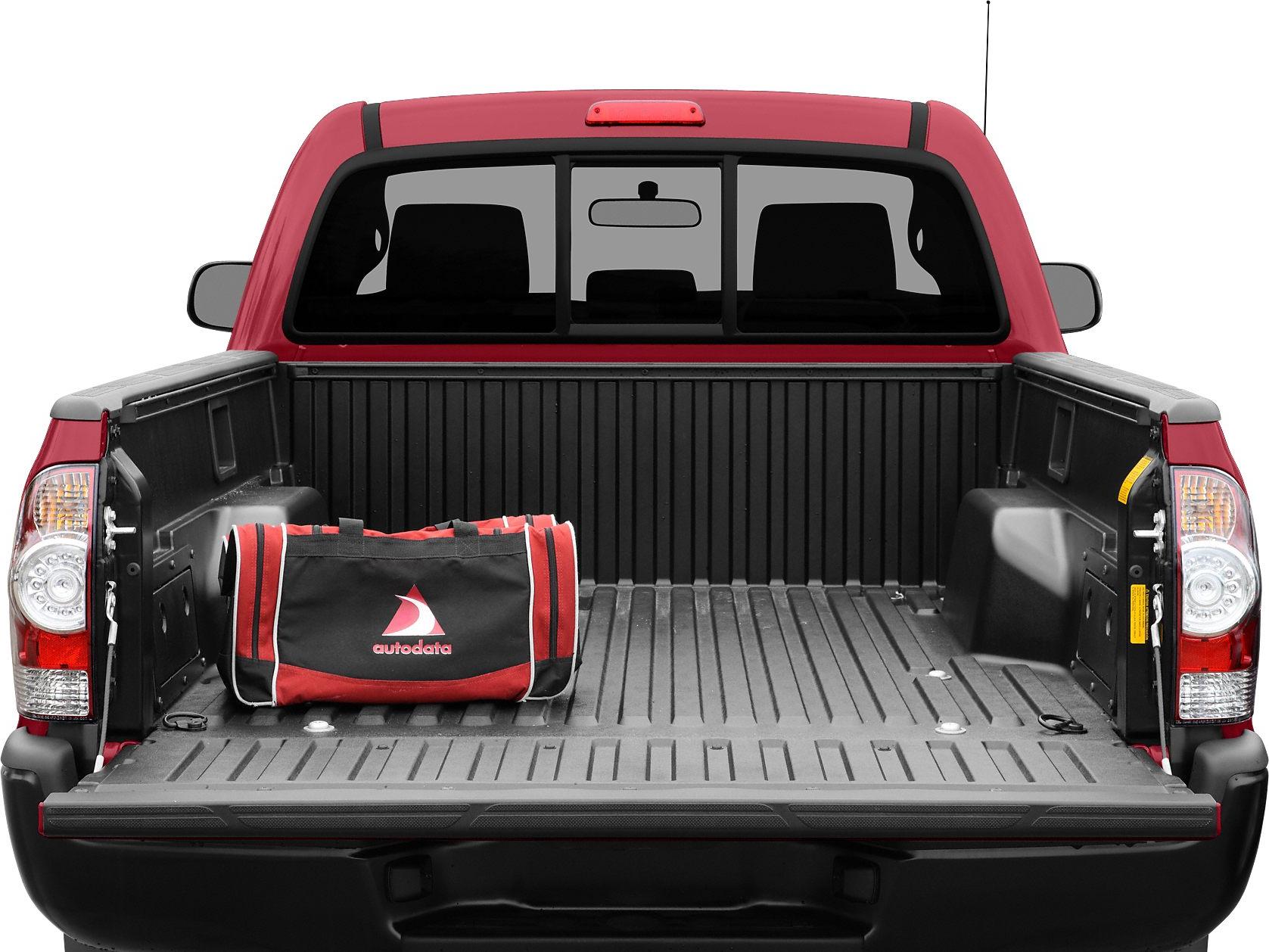 Open pickup truck bed with protective liner and a red-black soft-sided bag