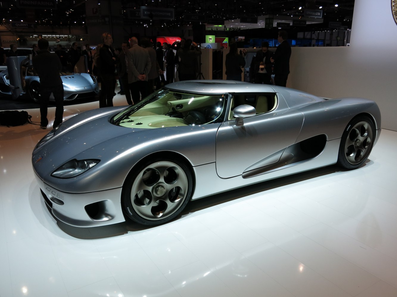 Silver low-profile supercar with unique wheels and aerodynamic body.
