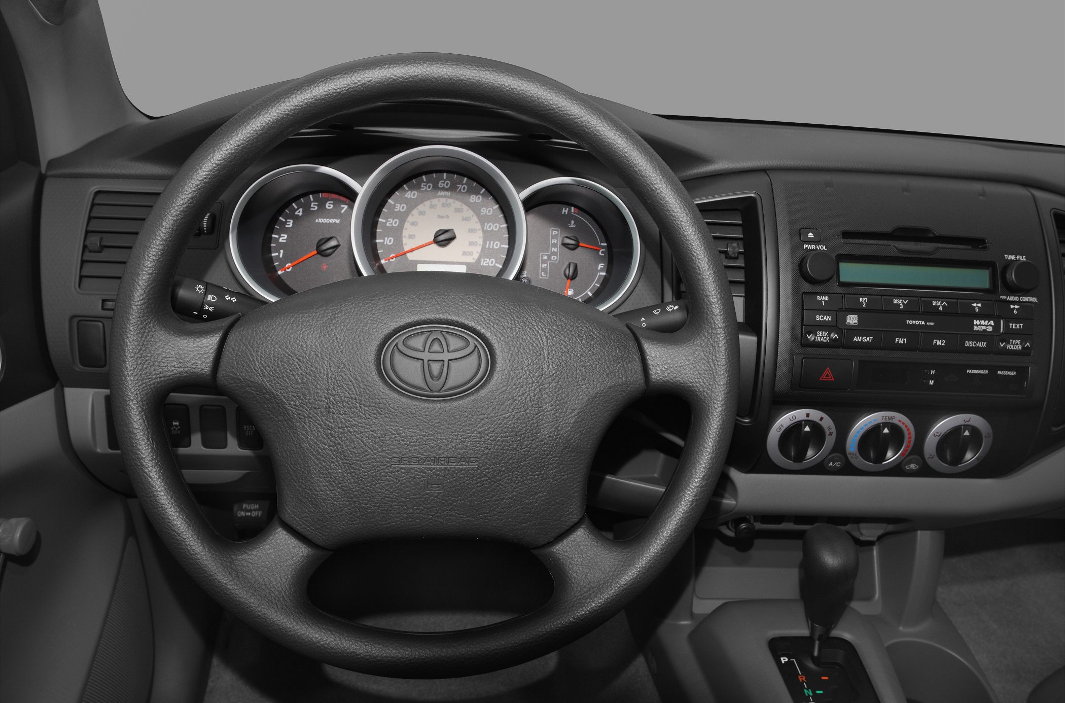 Steering wheel, instrument cluster, center console with HVAC and radio controls