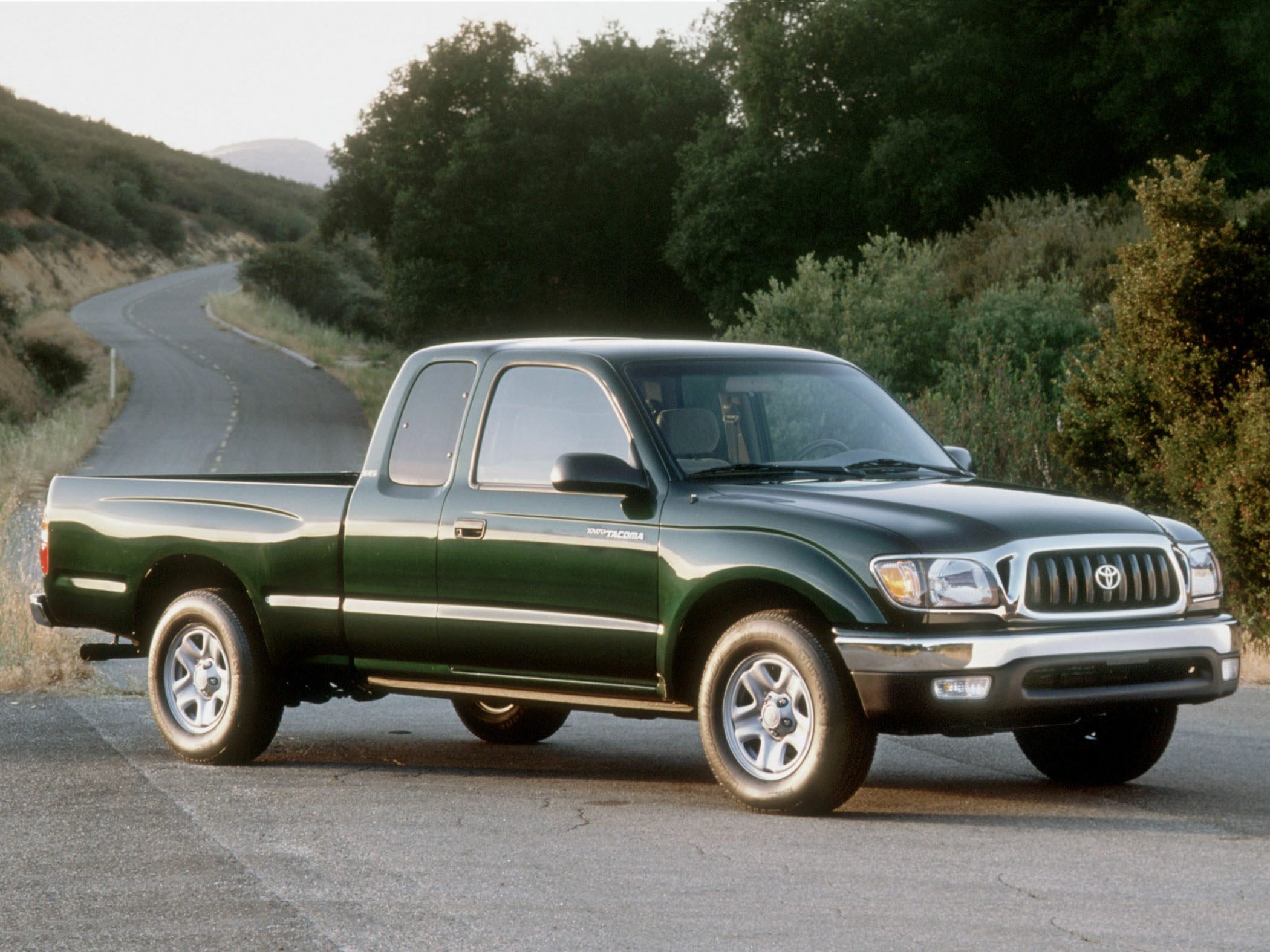 Extended cab pickup truck with chrome grille and alloy wheels.