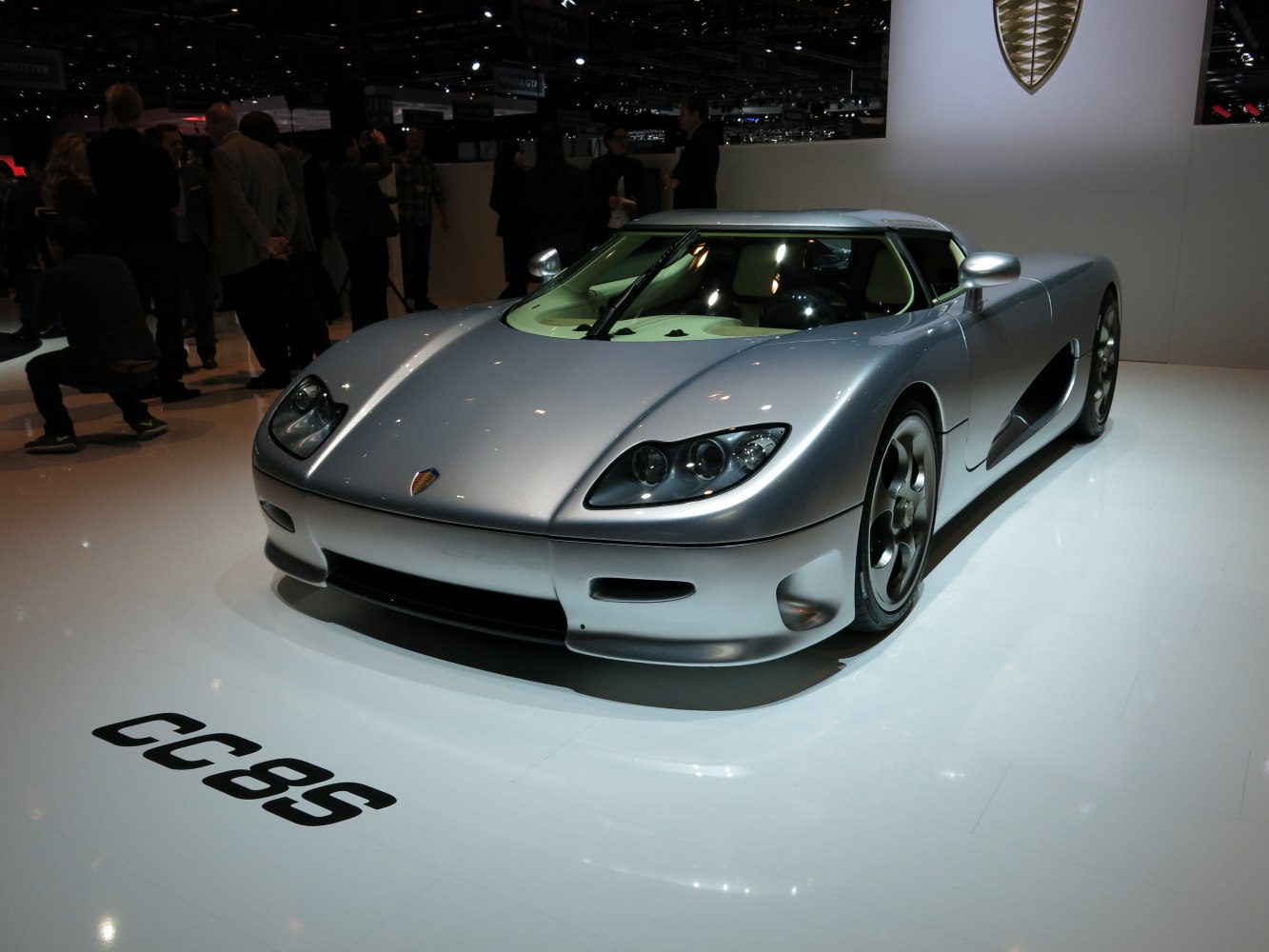 Silver supercar with aerodynamic body and distinctive front headlights